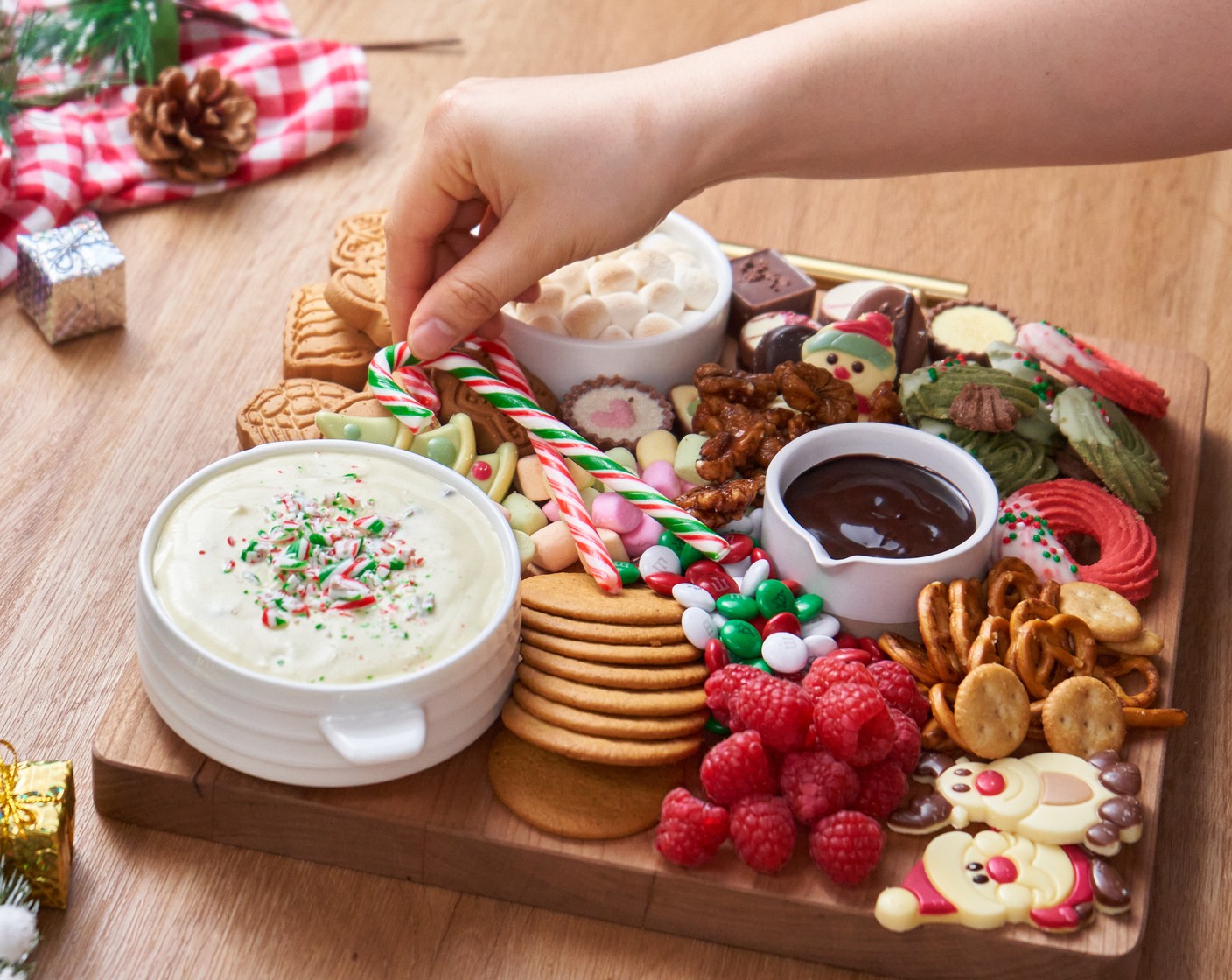 step 4 Arrange the White Chocolate (1/3 cup), Milk Chocolate (1/3 cup), Mini Colored Marshmallows (1/2 cup), M&M's® Milk Chocolate Candy Holiday Colors (1/4 cup), Candied Walnuts (1/4 cup), Fresh Raspberry (1/2 cup), Fresh Strawberry (1/2 cup), and Candy Canes (4) on the board to fill up the empty spaces, enjoy with family and friends!