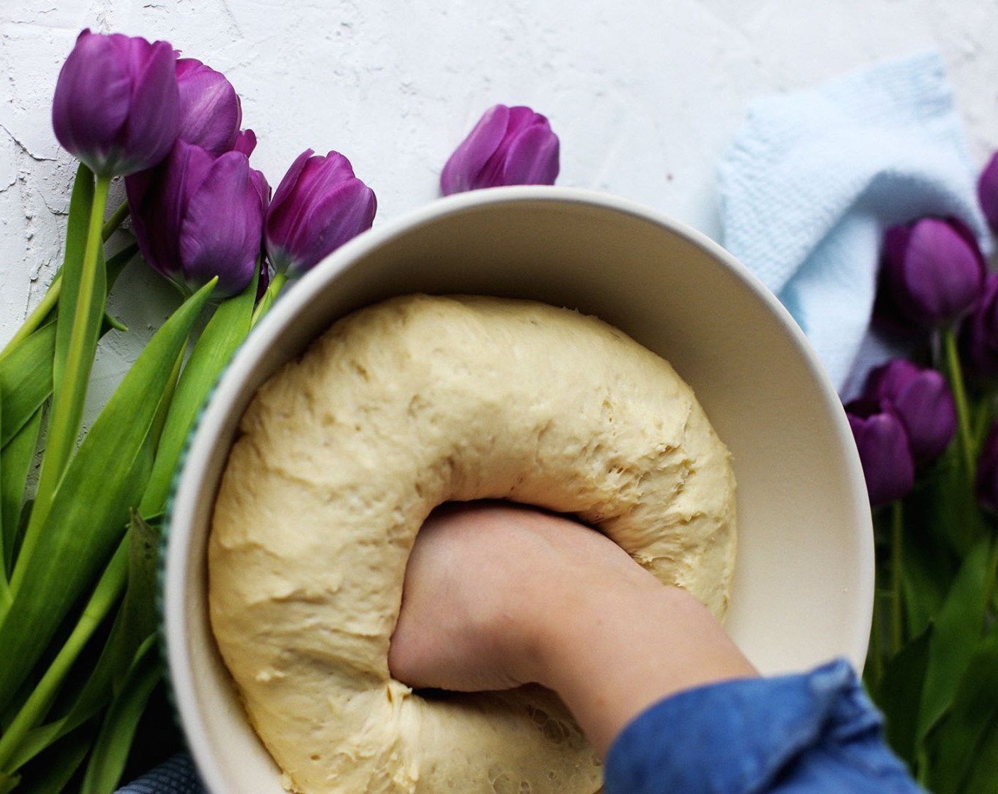 step 7 Place some oil on your knuckles and punch down the dough. The dough will be sticky. Dump onto a floured surface and roll out until dough is about 1/4-inch thick.