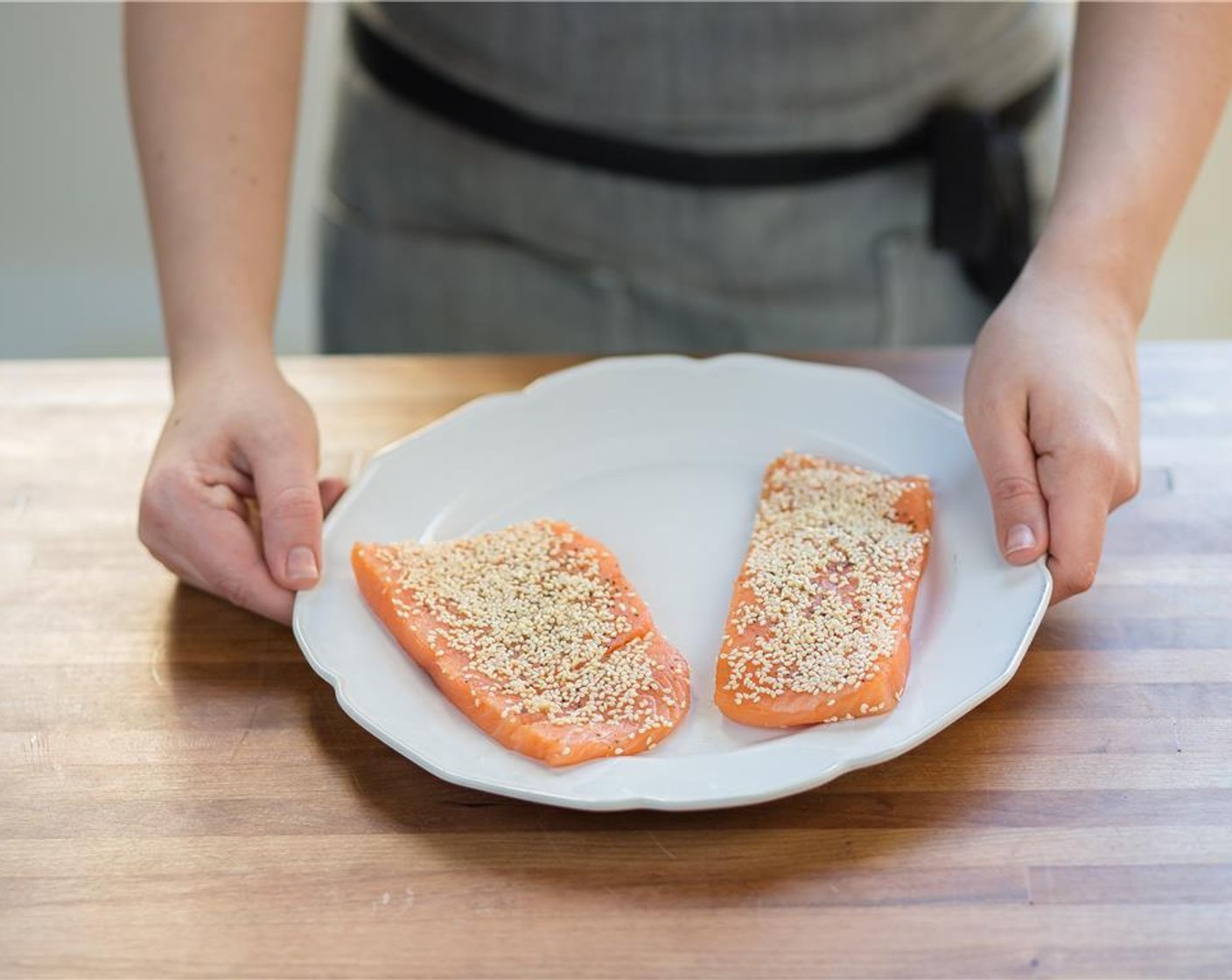 step 10 Pat dry Salmon Fillets (2) with the paper towels and season each fillet with Salt (1/4 tsp) and Ground Black Pepper (1/4 tsp). Evenly coat only one side of the salmon with White Sesame Seeds (2 Tbsp) and set aside.