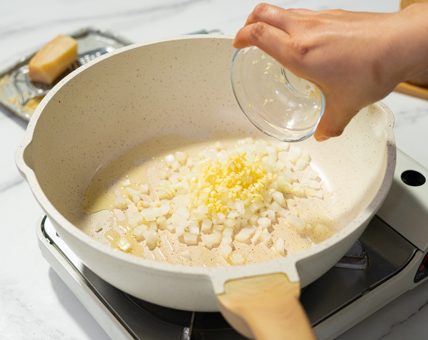 step 2 Heat the Olive Oil (1 1/2 Tbsp) in a high-sided pan over medium heat, and add the Yellow Onion (1/2) and Garlic (3 cloves) to the pan. Cook until onions are translucent.