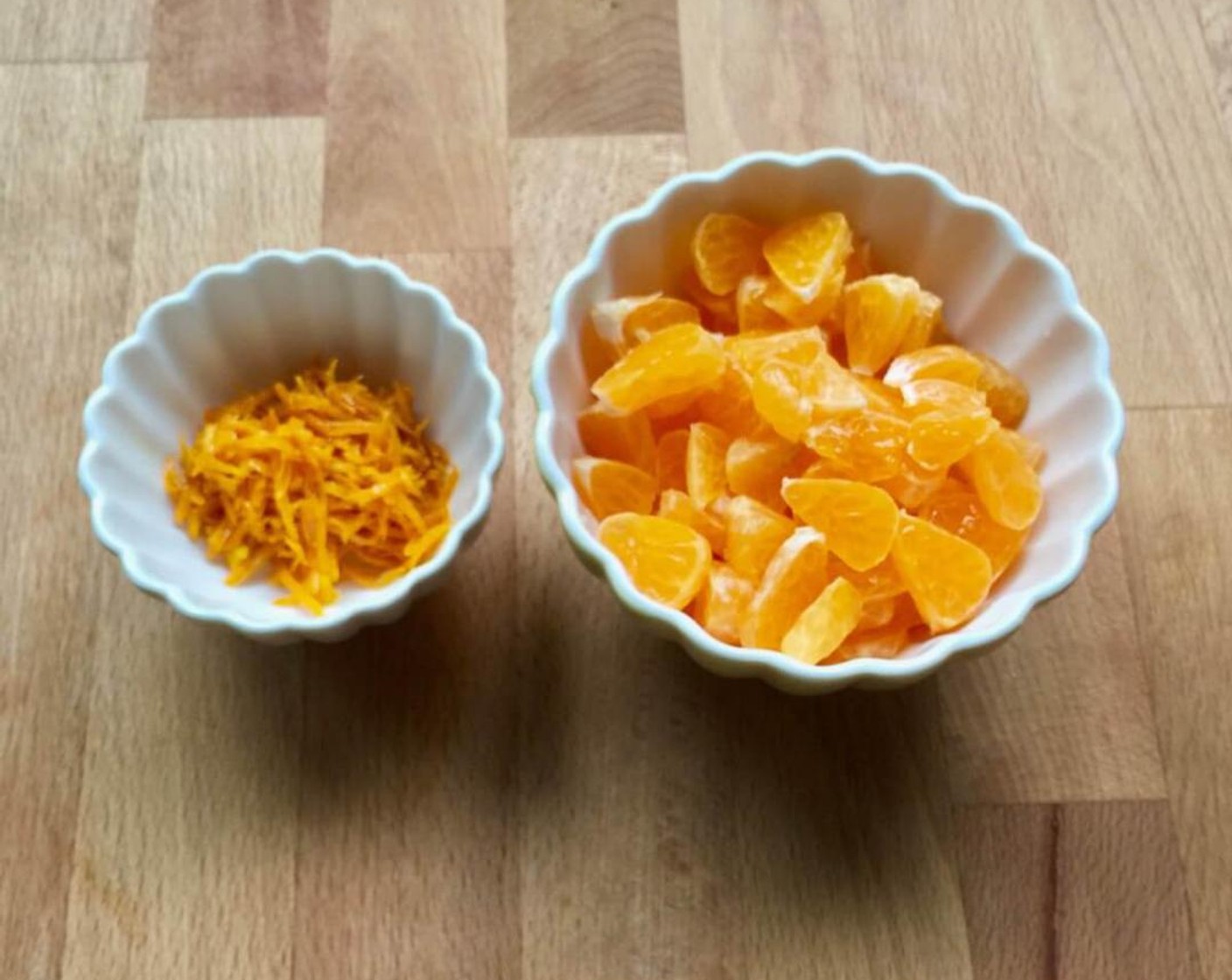 step 1 First, clean and rinse the Mandarin Orange (1 cup) well. Then using a vegetable shredder, grate the orange rind. You will need 1/2 cup of orange rind. Peel to remove the skin, remove pith, seeds and break into segments. Then, using a sharp knife, cut the segmented mandarin oranges into small pieces.