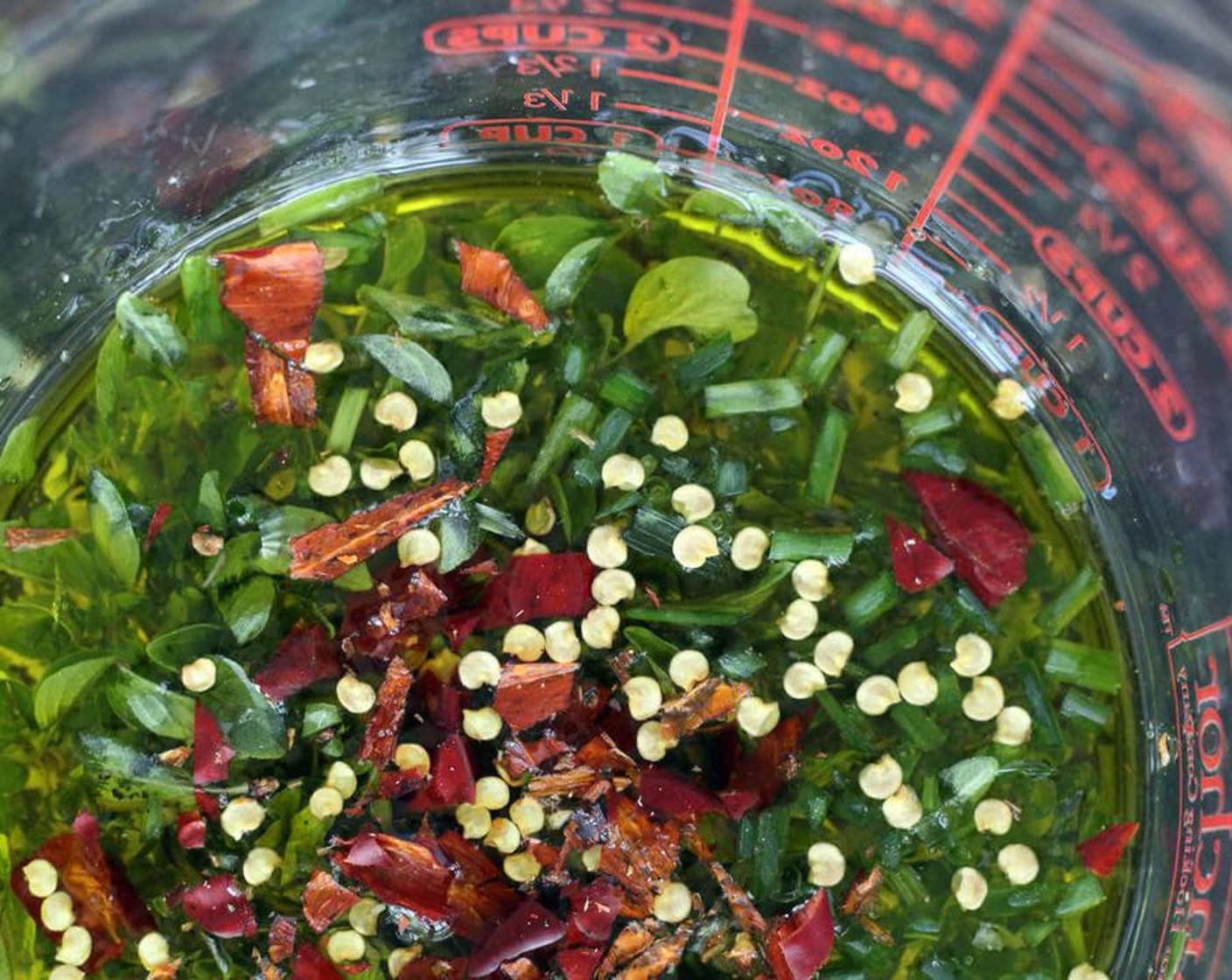 step 2 In a small bowl or measuring glass, combine Ground Black Pepper (1/2 tsp), Sea Salt (1/2 tsp), Extra-Virgin Olive Oil (1/2 cup), White Wine Vinegar (1/2 cup), Garlic (4 cloves), Fresh Oregano (3 Tbsp), Fresh Chives (3 Tbsp), Red Fresno Chili Peppers (2), and Granulated Sugar (1 tsp) until well blended.