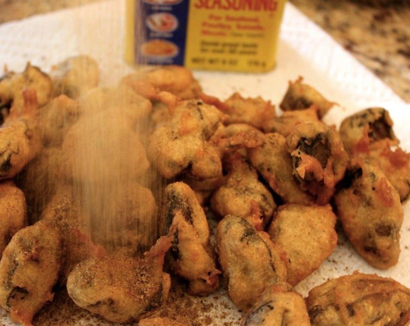 step 7 Sprinkle the oysters with Old Bay® Seasoning (2 pinches) while they are warm.