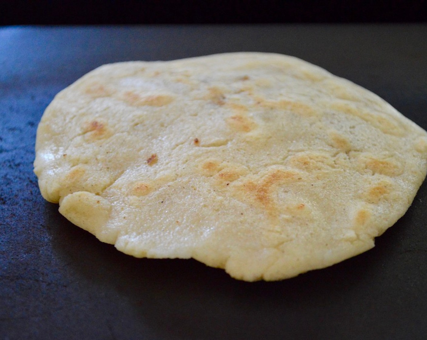 step 15 Get the pupusa onto the hot griddle and cook it for about 3 minutes on each side. It should get golden with little sun spots on the outside. Keep forming and cooking the pupusas this way until the dough is all used up.