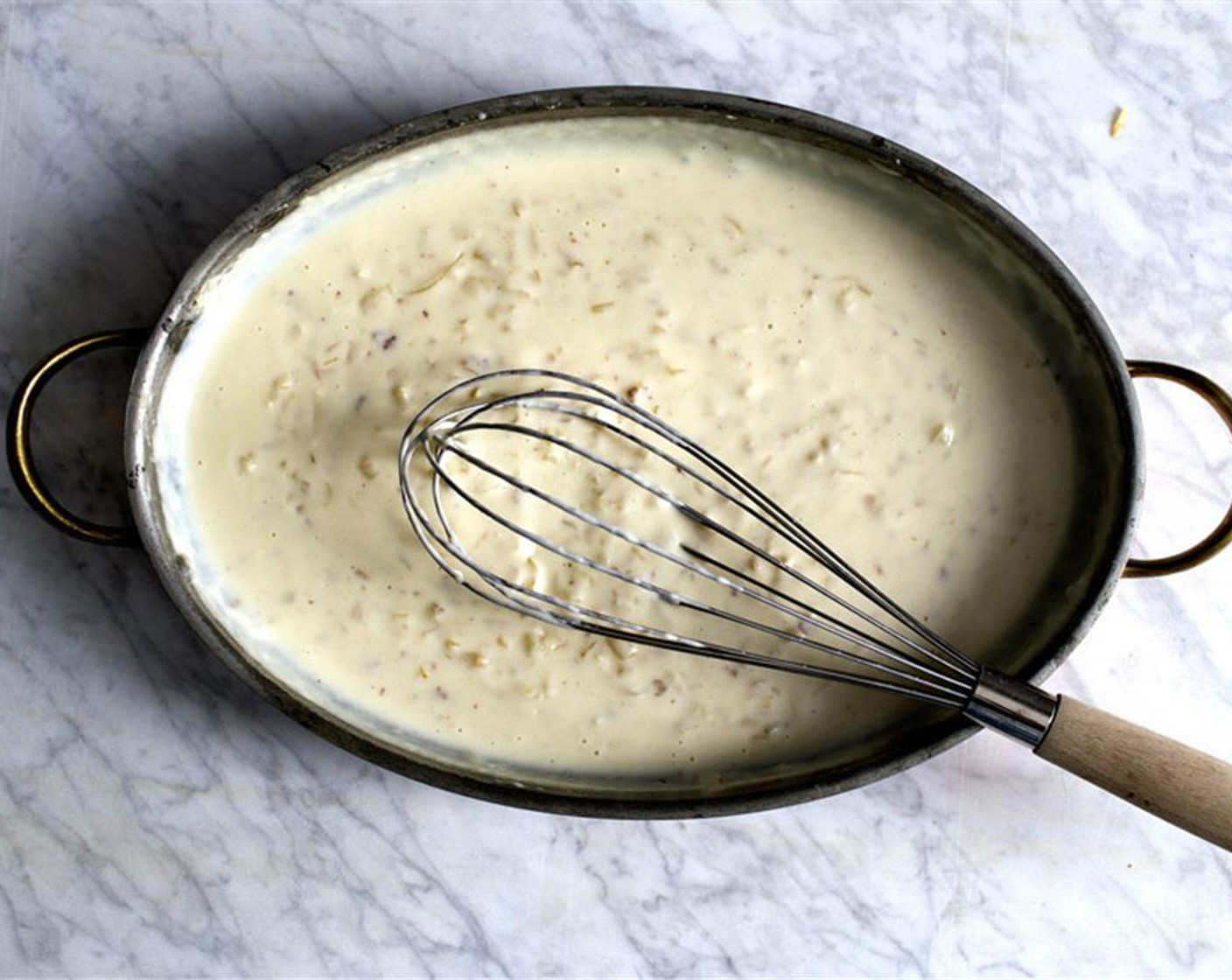 step 14 Add the Milk (3 cups) and Chicken Stock (1/4 cup). Keep whisking until the mixture has come to a simmer and starts to thicken. Add the browned sausage back to the skillet.