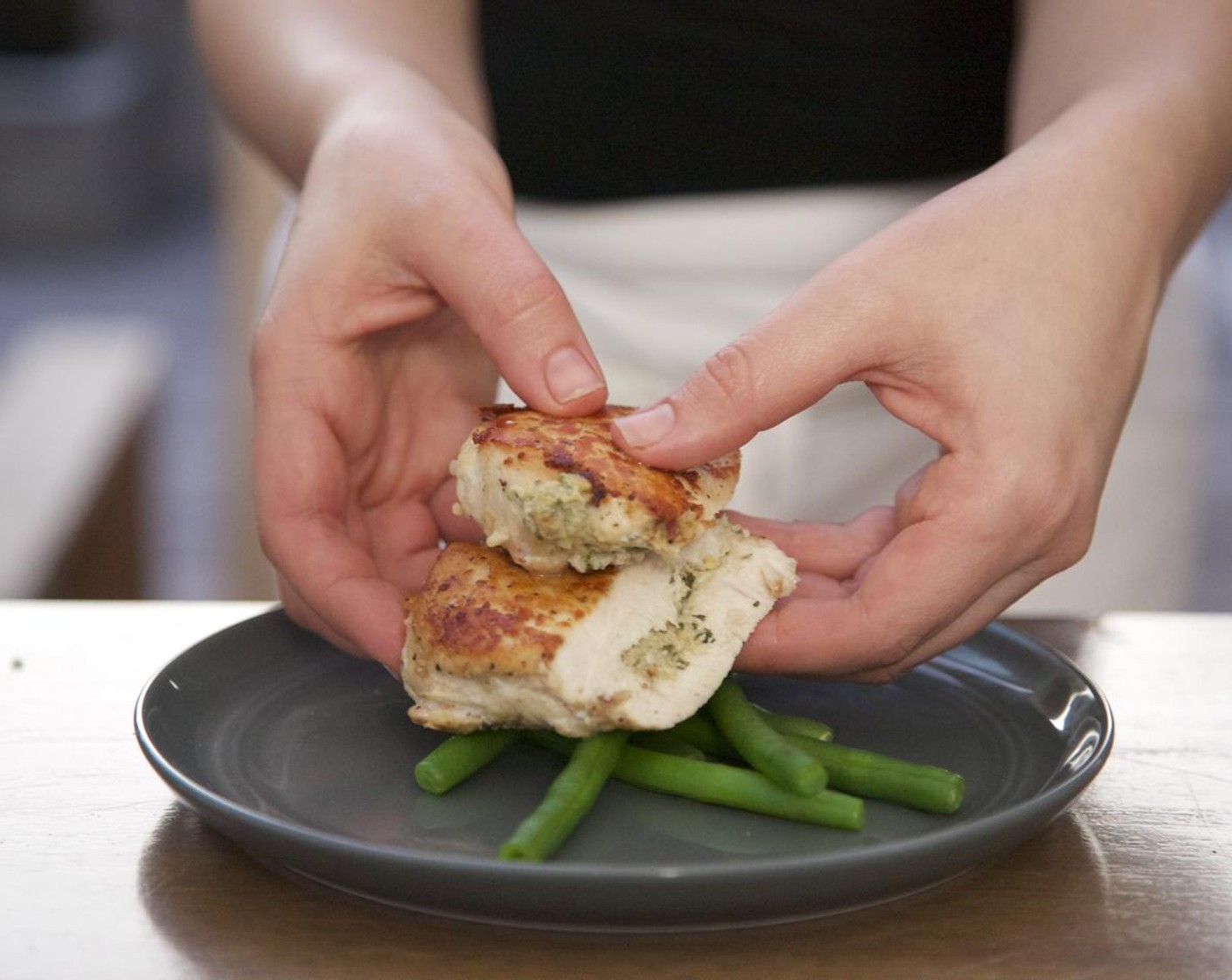 step 12 Divide the green beans equally between two plates. Slice each chicken breast in half at a diagonal angle. Place the chicken on top of the green beans.