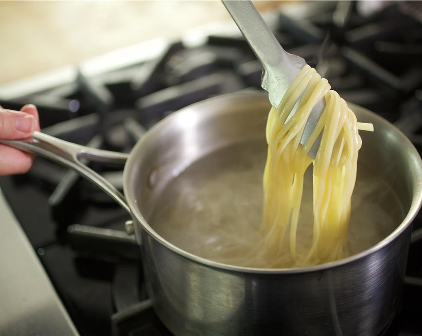 step 3 When water comes to a boil, add the Linguine (3 oz) and cook for 12 minutes. After two minutes of cooking, separate the noodles with tongs and repeat every three to four minutes to prevent the noodles from sticking. Drain into a colander and return to saucepan.