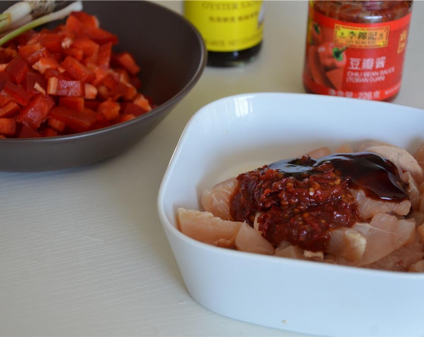 step 4 Marinate the chicken in Corn Starch (1/2 tsp), Chili Bean Sauce (2 Tbsp) and Oyster Sauce (1 Tbsp) for 15 minutes.