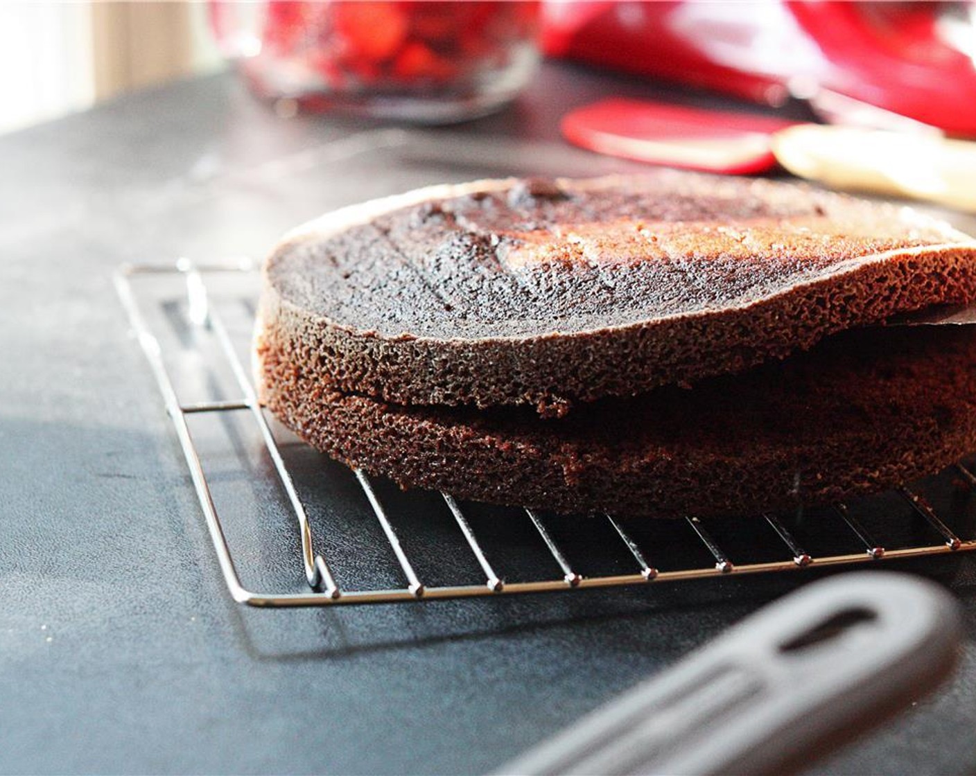 step 14 Slice each layer of chocolate cake in two using a good bread knife. I find it’s easiest to rotate the layer while you are slicing, making sure you keep the knife level as it slices around the cake.