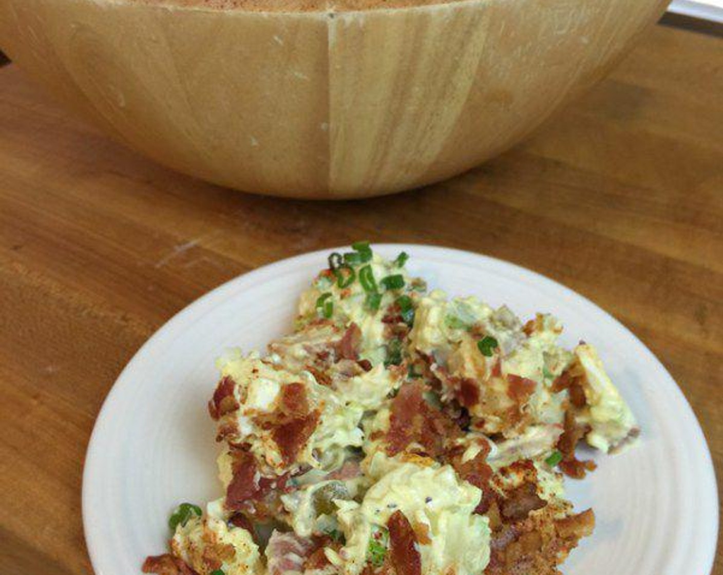 step 3 Then it’s time to top this potato salad. First sprinkle Paprika (to taste) over the top, then crumble Bacon (1 lb) over the top. Then add Scallions (2) to the top for color.