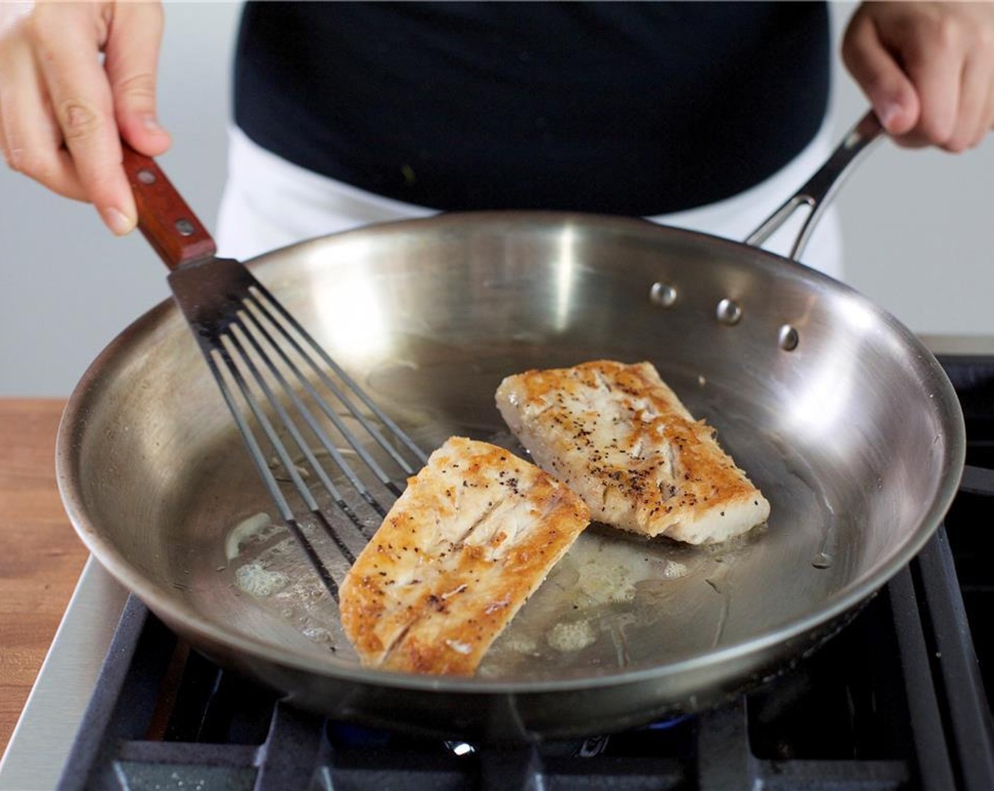 step 6 When the pan is hot, place the fish in the pan and sear on each side for 3 minutes. Remove the fish from the saute pan and add Olive Oil (1 Tbsp).