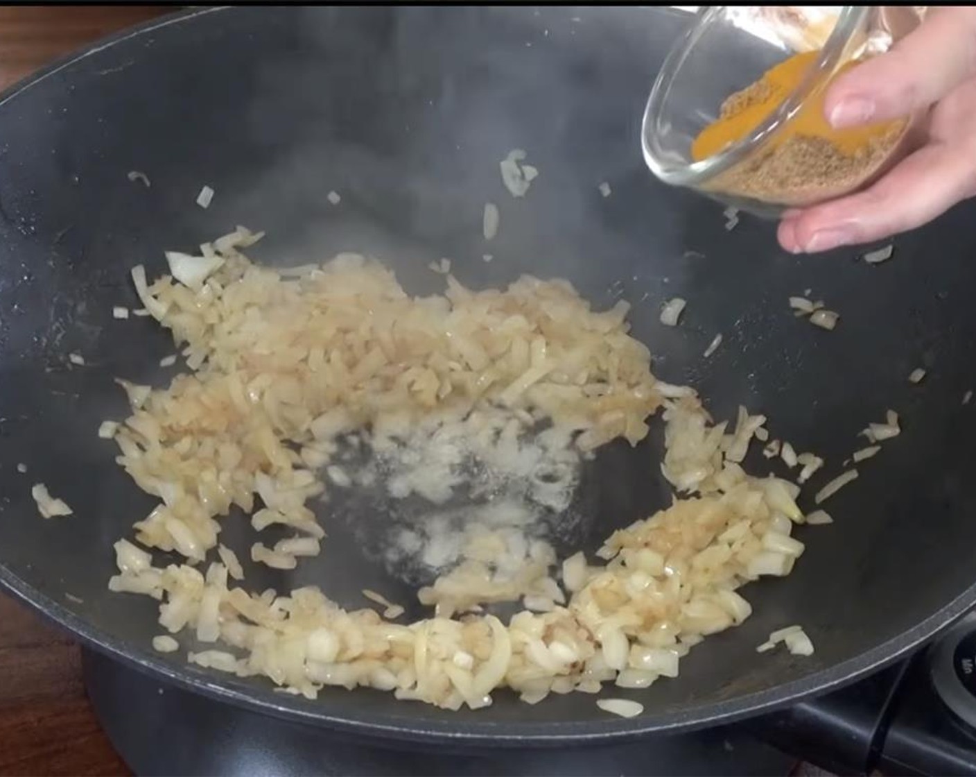 step 5 Make a well in the middle and add the remaining Coconut Oil (1 tsp). Add the turmeric spice mix. Allow the spices to cook for a couple of minutes.