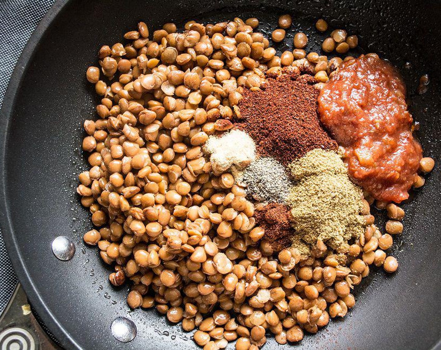 step 4 Meanwhile, add Lentils (1 can) to saute pan with Chili Powder (1/2 Tbsp), Ground Cumin (1 tsp), Ground Black Pepper (1/2 tsp), Sea Salt (1/4 tsp), Garlic Powder (1/4 tsp), Chipotle Chili Powder (1/8 tsp), and Salsa (2 Tbsp). Cook 5-7 minutes or until heated through. Stirring occasionally.