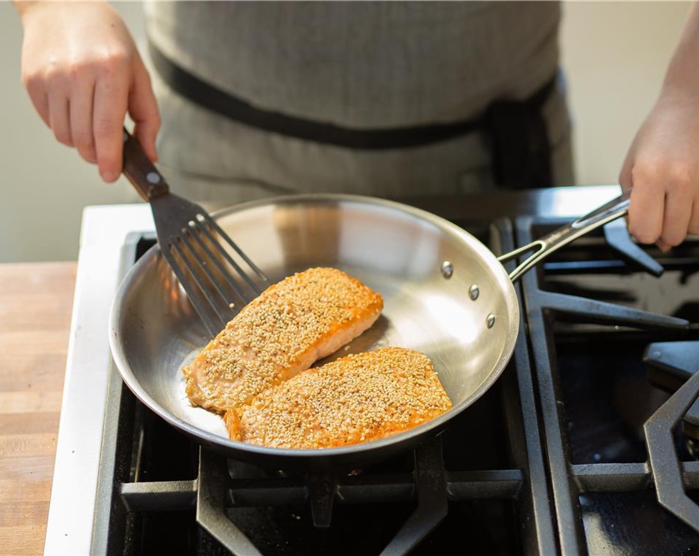 step 11 Heat Olive Oil (2 Tbsp) in a medium oven proof saute pan over medium high heat. When hot, add the salmon with the sesame seed side down. Sear for 1 minute. Do not turn fish.