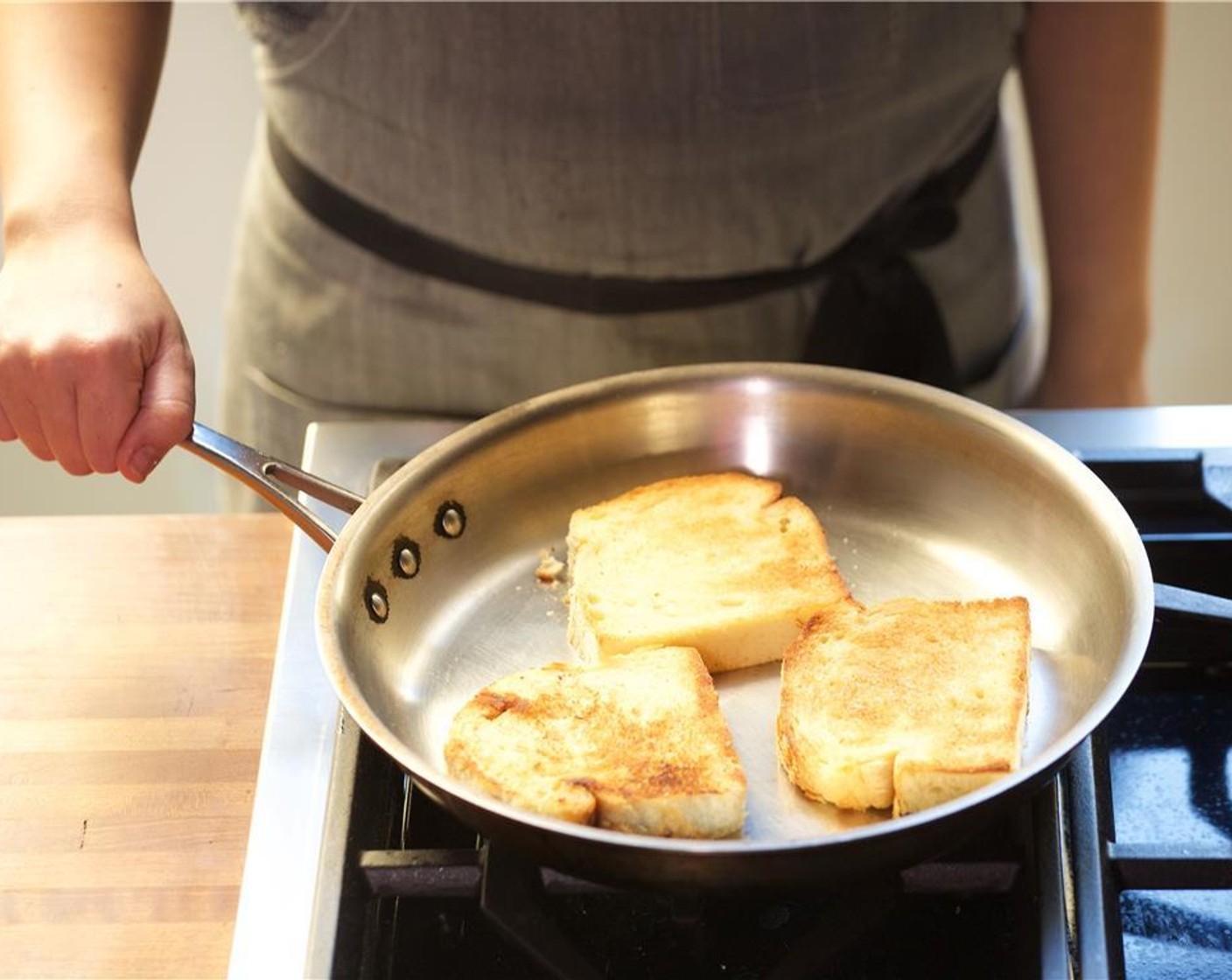 step 9 In a large saute pan over medium heat, add Olive Oil (1 Tbsp). Add the brioche (3 slice) and cook on each side for one minute until golden brown. Remove from heat and set aside,