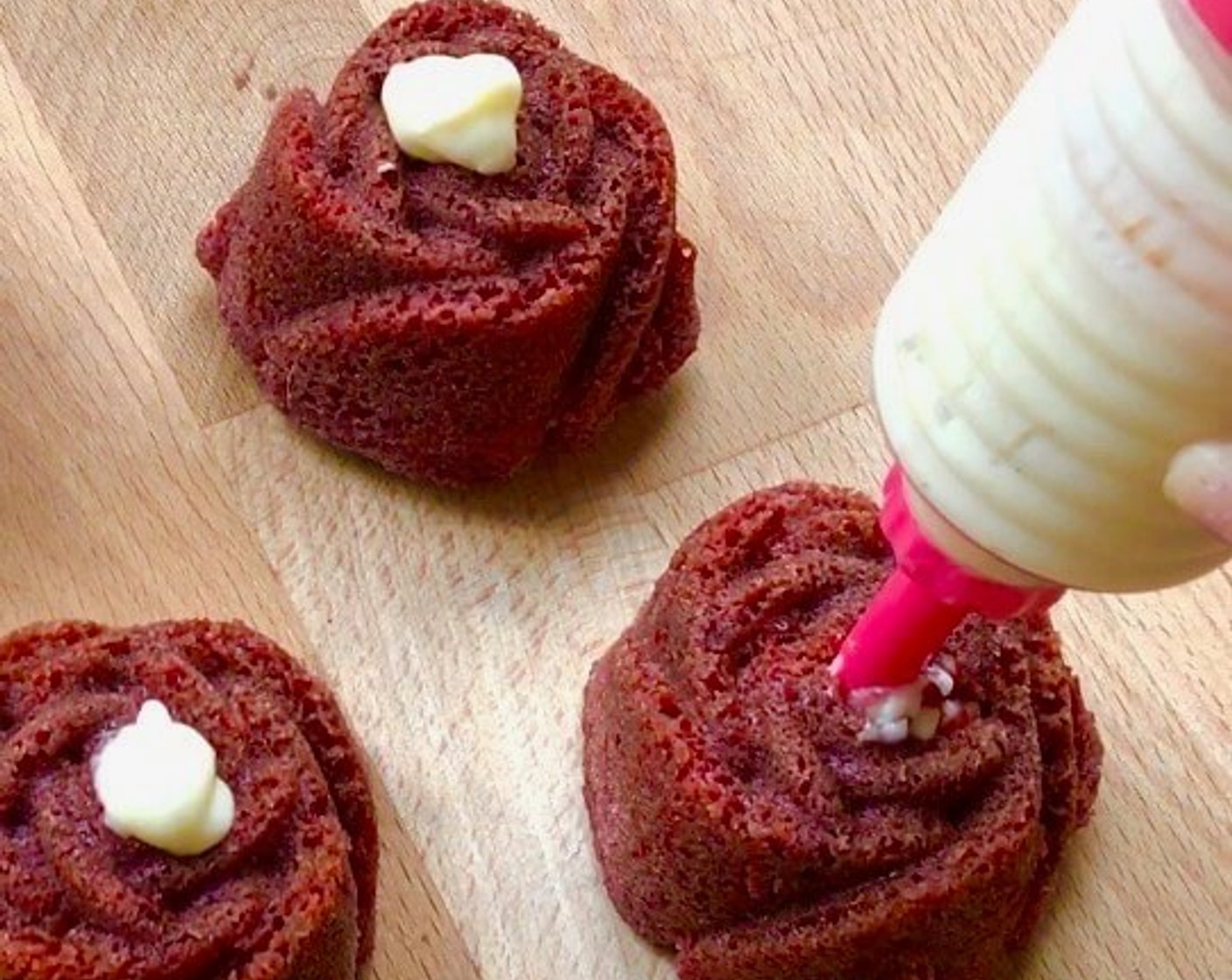 step 18 Fill the cream in a piping bag and pipe into the red velvet cupcakes. And we're done!