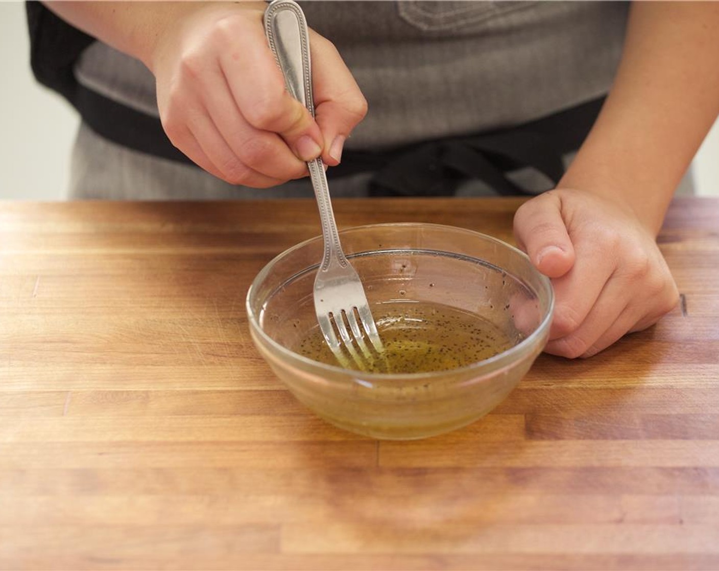 step 2 In a medium bowl mix together Champagne Vinegar (2 Tbsp), Salt (1/4 tsp), and Ground Black Pepper (1/4 tsp) with Olive Oil (1 Tbsp). Mix until well combined.