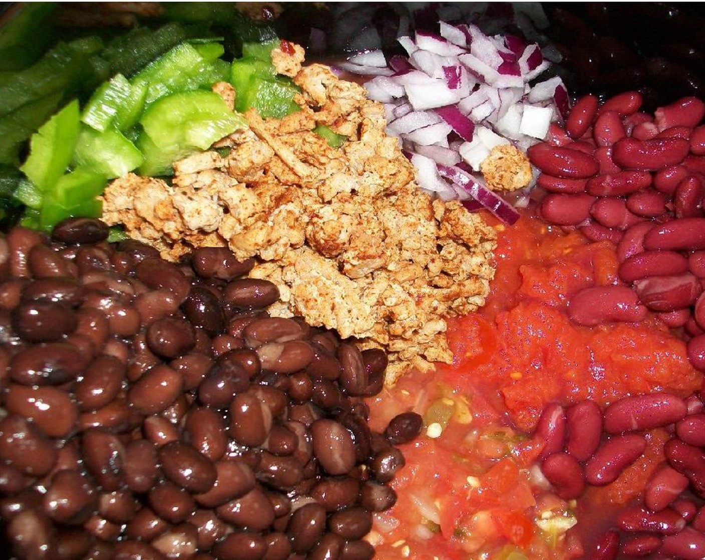 step 2 Place the browned and seasoned ground turkey in your pot. Now just pile in Onion (1), Green Bell Pepper (1/2), Diced Tomatoes (1 can), Salsa (4 Tbsp), Black Beans (1 can), and Red Kidney Beans (1 can).
