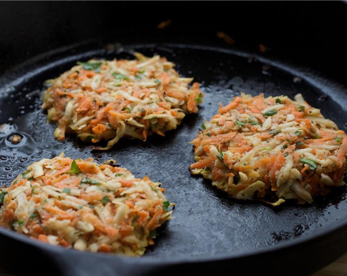 step 7 Heat Grapeseed Oil (1 Tbsp) over medium heat in a heavy skillet, preferably cast iron. When the oil is hot, form half-cup pancakes with your hands and place them in the skillet, pressing gently with a spatula to achieve a half-inch thickness.