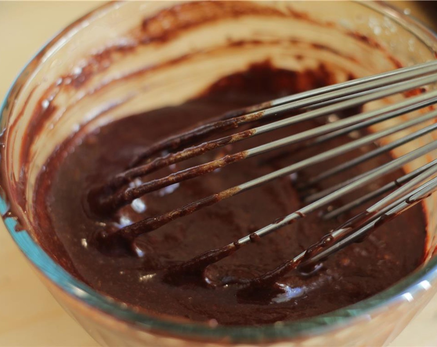 step 5 When chocolate is melted, pour it slowly into egg mixture, whisking to combine. Go very slowly at first to make sure the eggs do not cook.