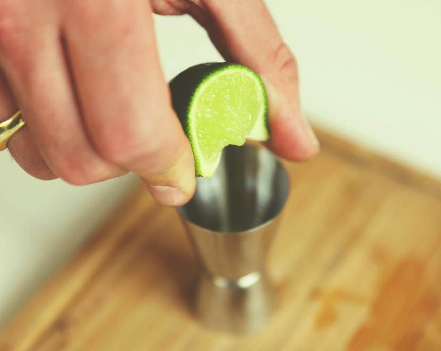 step 2 Add the juice of half the lime to the Jigger (metal cup shaped like a shot glass).