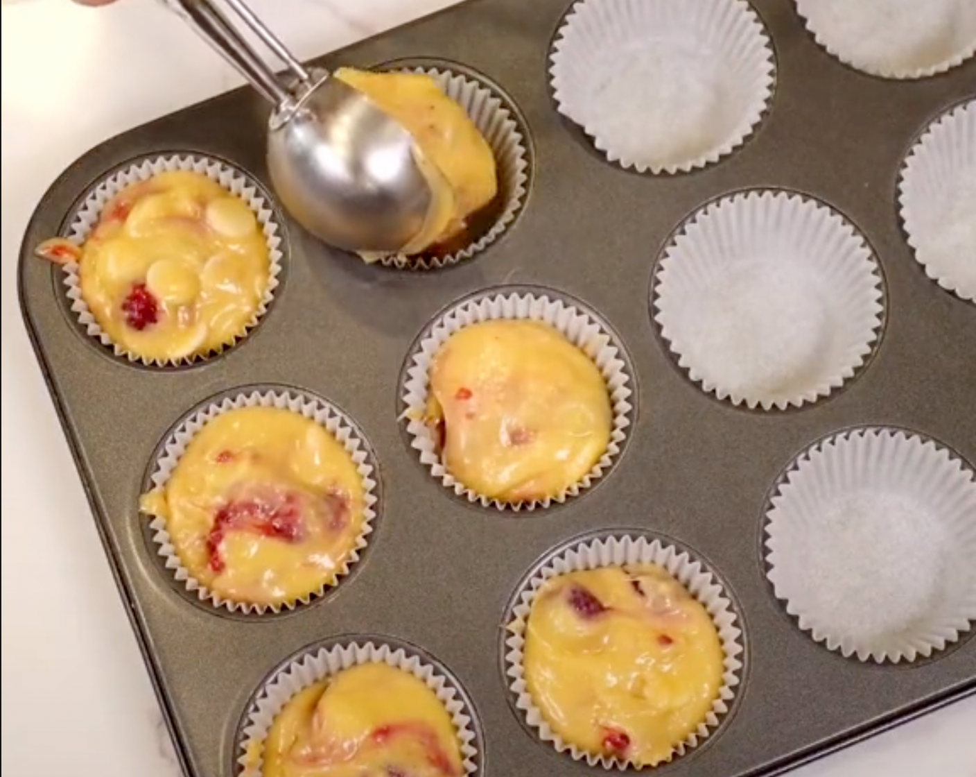 step 5 Then, transfer batter in large scoops to your muffin pan lined with paper liner.