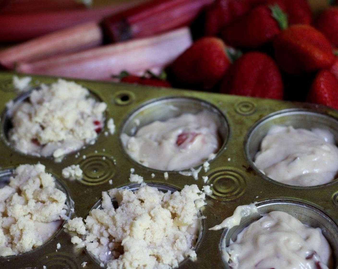 step 7 Divide the batter evenly among the 12 cups in a muffin tin. Sprinkle the streusel on top.