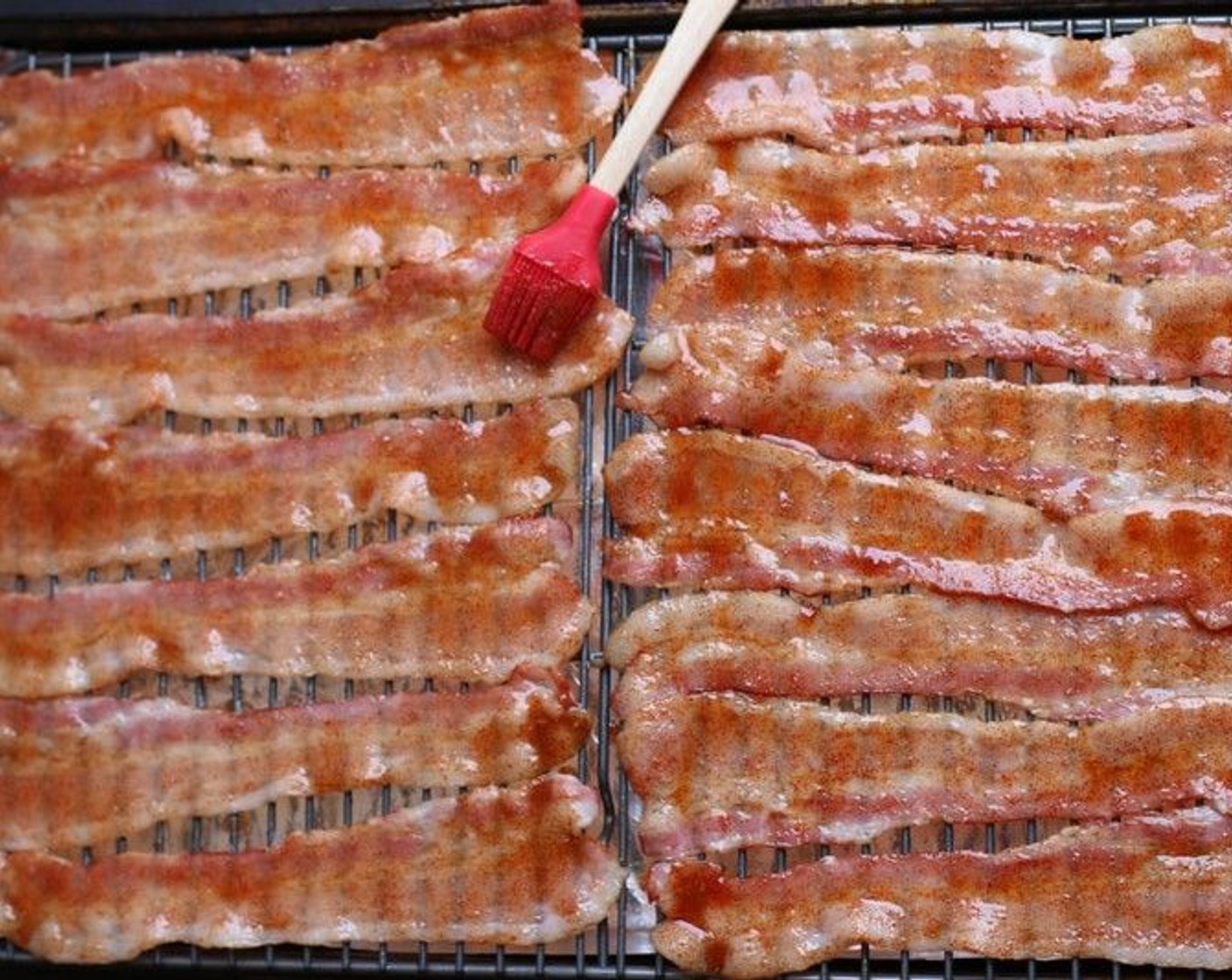 step 4 Remove pan from the oven and flip the bacon slices. Using a silicone brush or small spoon, spread the maple syrup mixture evenly over the top of each bacon slice – you’ll use half of the syrup.