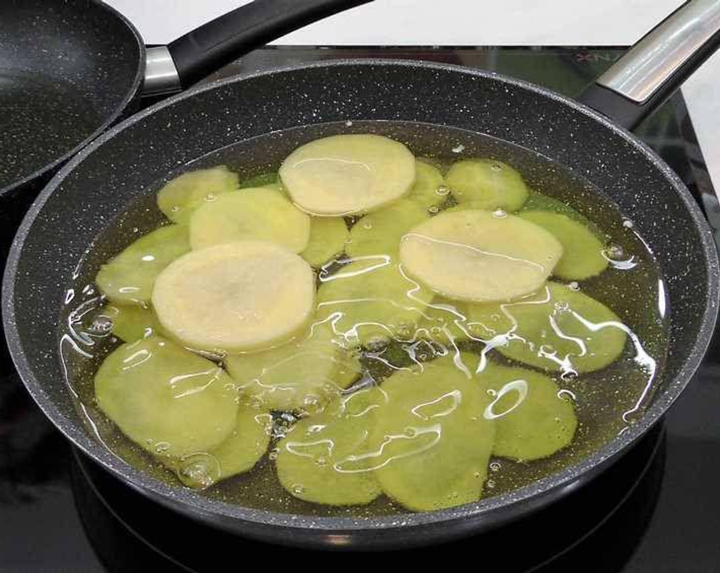 step 3 Season potatoes with Salt (to taste) and fry the potato slices in Olive Oil (as needed) at high heat.
