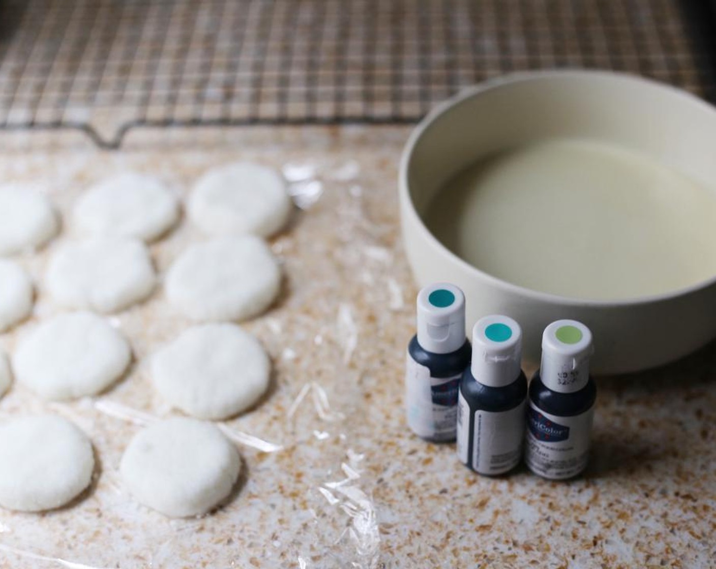 step 6 Remove the patties from the fridge and begin decorating them. Add a few drops of AmeriColor Flo-Coat™ (to taste) to the White Chocolate (1 cup).