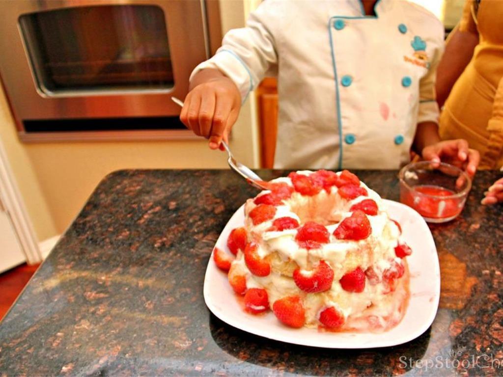 Step 6 of YaYa's No-Bake Strawberry Shortcake Recipe: Add the second layer of cake and remaining Whipped Cream (1 1/2 cup), then both fresh and frozen strawberries on top and sides. That's it! Now it is ready to slice and serve.