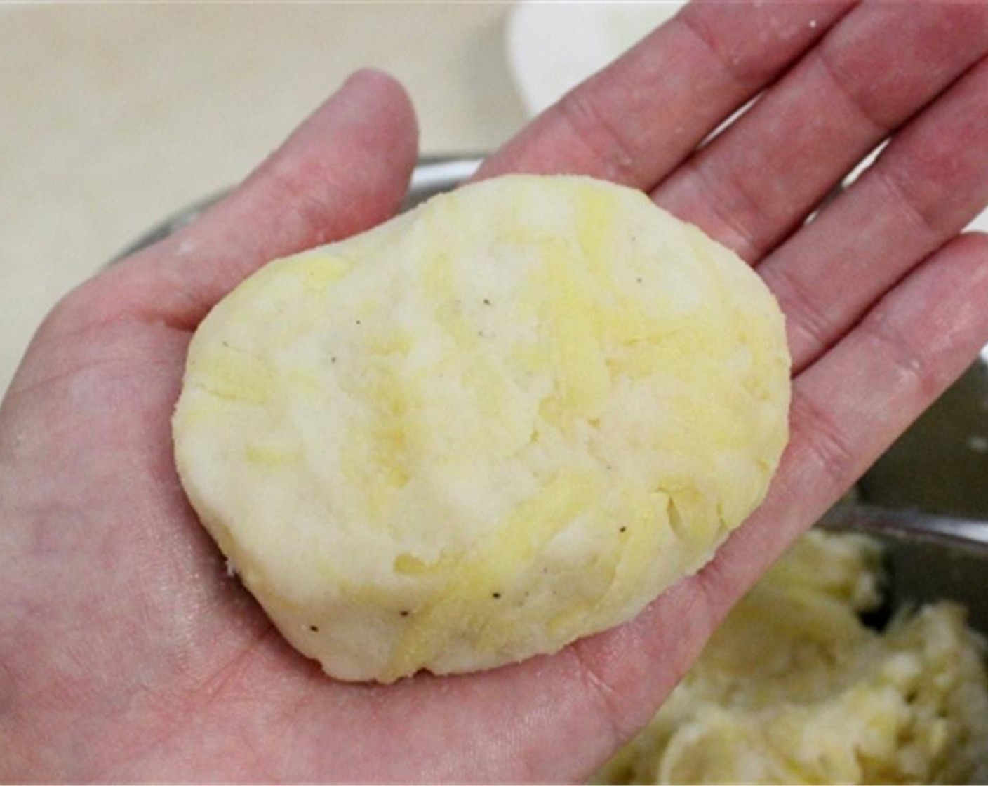 step 5 Fold the potato mixture over the cheese filling, shaping it into an oval shape.