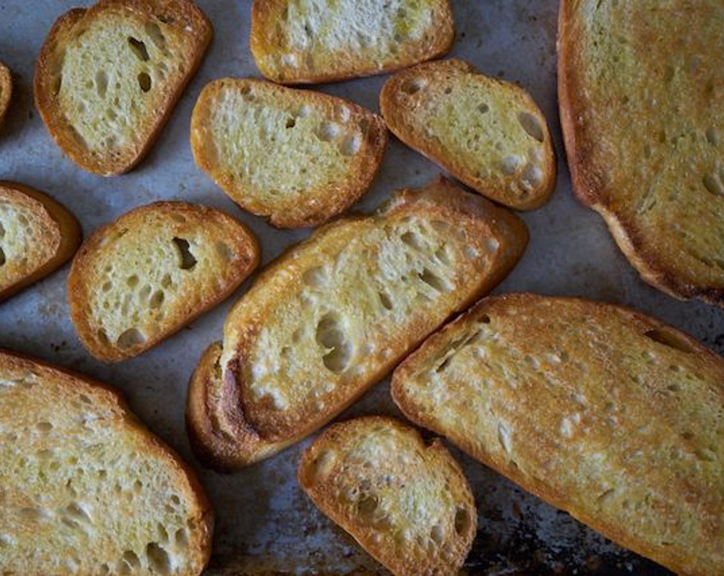 step 4 When bread is golden brown, remove from oven and rub slices on one side with the whole clove of Garlic (1 clove). Season with some Kosher Salt (to taste) and set aside.