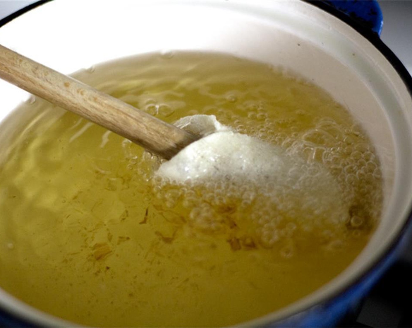 step 5 Keep the wooden spoon inserted until the shell has puffed and set in shape. Then remove it. Fry the shell until golden brown on all sides. Once removed, you can use the spoon to fry the next shell as long it doesn't crowd the pot.