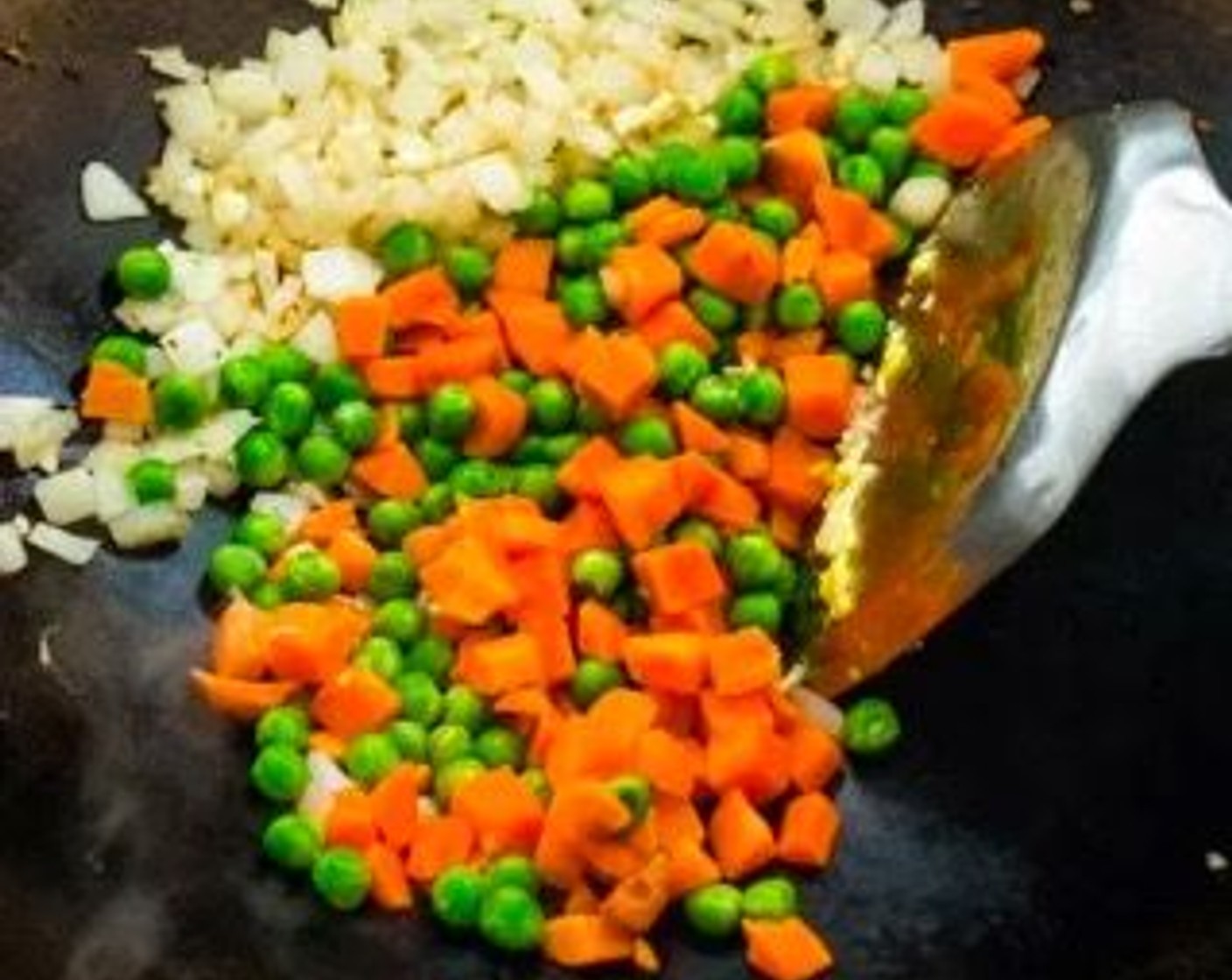 step 4 Add the Frozen Peas and Carrots (1 cup) to the wok. Stir-fry for about 30 seconds.