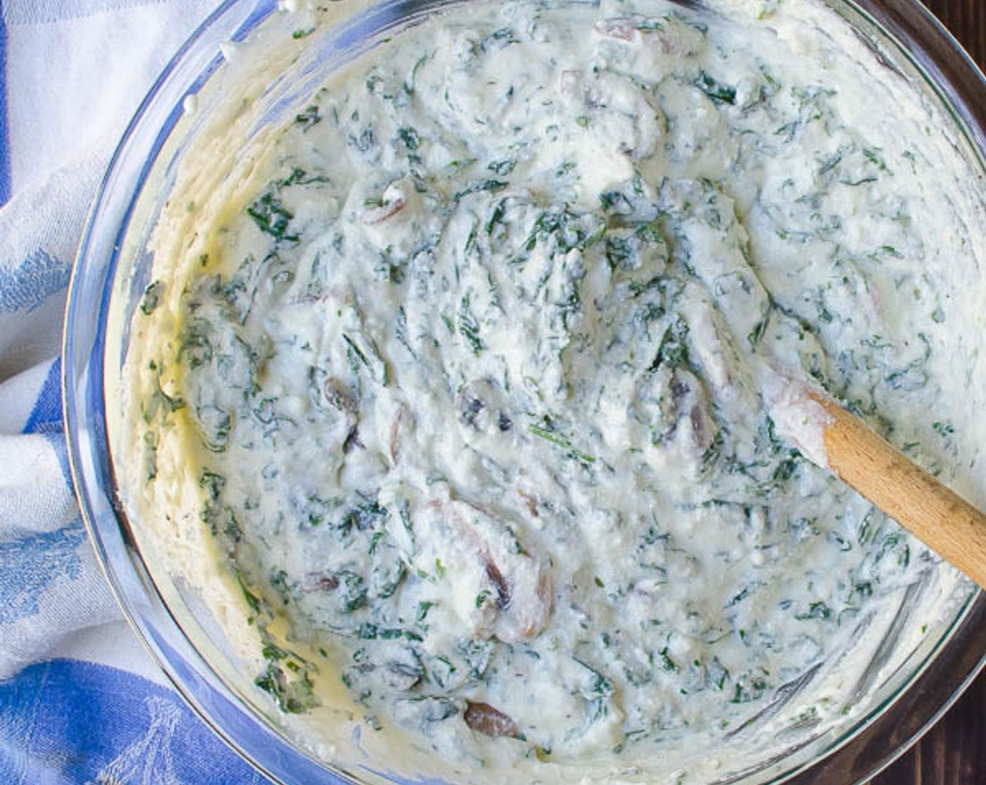 step 7 Add the mushrooms and kale to the ricotta mixture and stir completely to evenly distribute the vegetables throughout the ricotta.