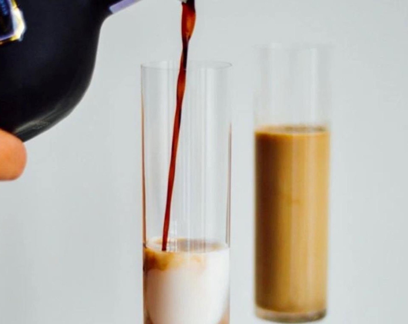 step 1 Combine Bailey's® Irish Cream (1 fl oz), PATRÓN® XO Café Coffee Liqueur (1 fl oz), Unsweetened Almond Milk (4 Tbsp), and Grand Marnier (1 Tbsp) into a glass.