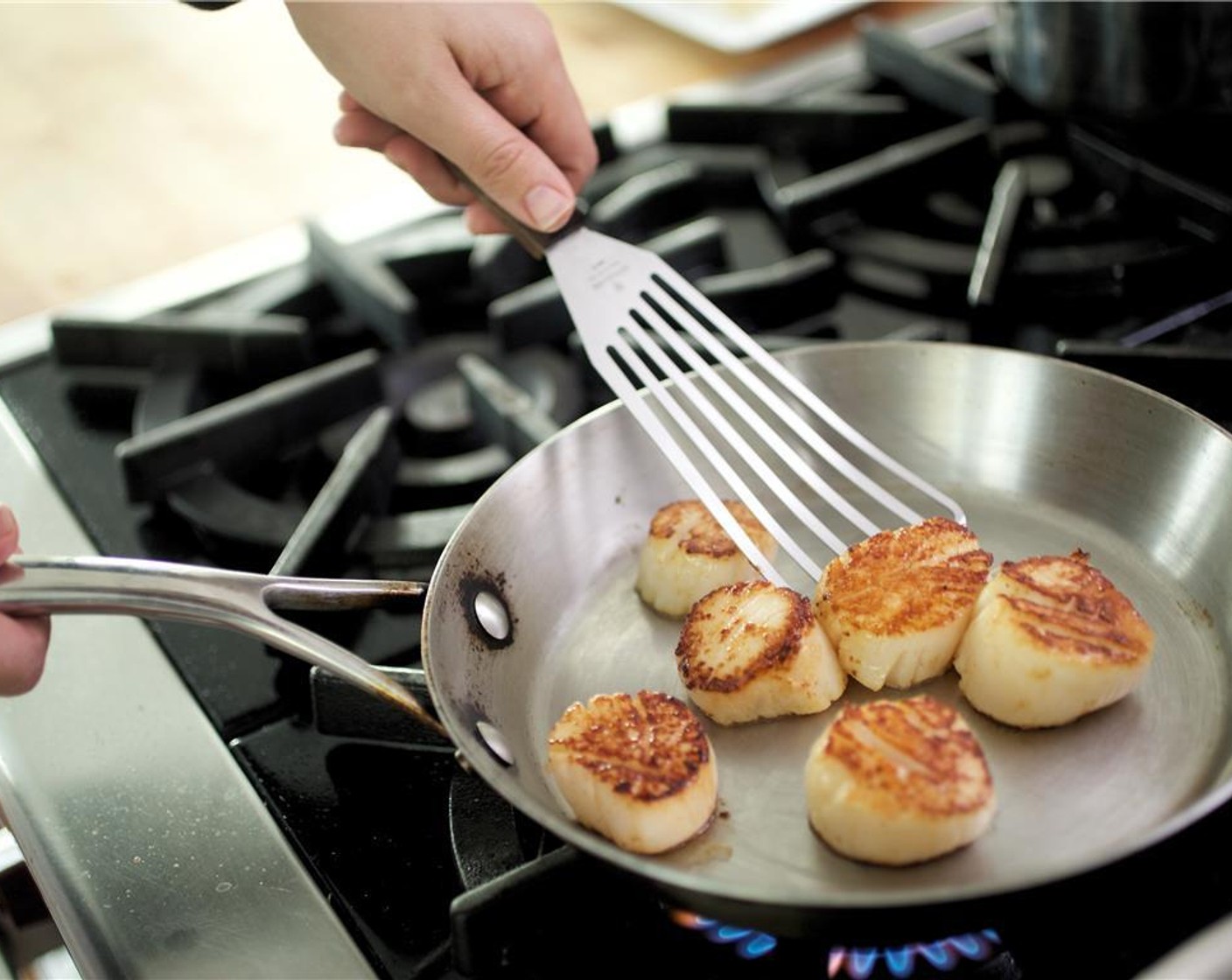 step 9 Turn scallops over and cook for 1 minute. Remove from heat and hold until plating.