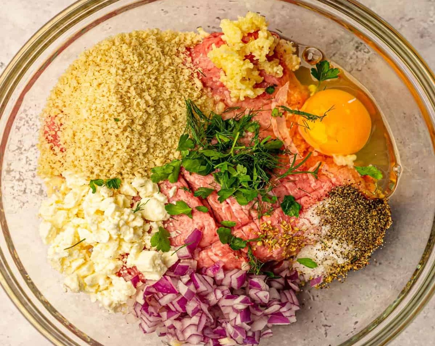 step 2 In a large bowl, combine Ground Turkey (1 lb), Eggland's Best Classic Egg (1), Panko Breadcrumbs (4 Tbsp), Red Onions (4 Tbsp), Garlic (3 cloves), Lemon Juice (1/2), Crumbled Feta Cheese (4 Tbsp), Dried Oregano (1/2 tsp), Fresh Parsley (1 Tbsp), Salt (1 tsp), and Ground Black Pepper (1/2 tsp). Use your hands to mix everything together.