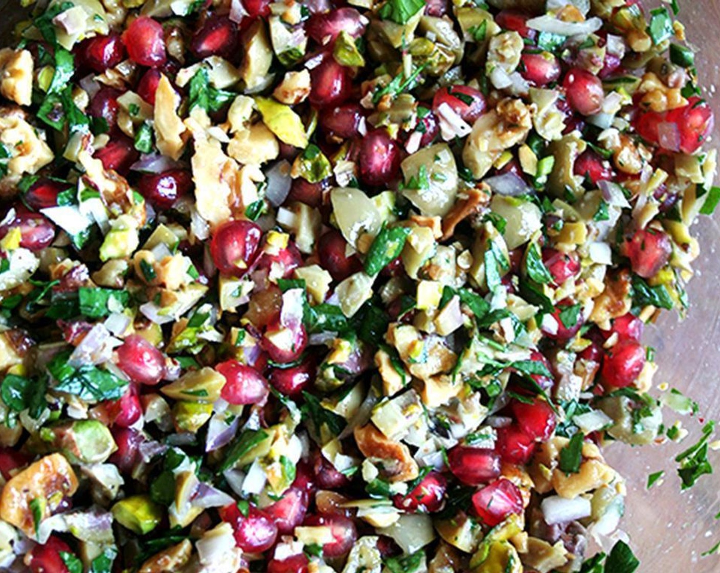 step 3 Combine Italian Flat-Leaf Parsley (1 Tbsp), Serrano Chili (1), Shallots (2), Shelled Unsalted Pistachios (1/4 cup), Green Olives (1/2 cup), {@10:}, walnuts, Pomegranate Seeds (1/2 cup), Extra-Virgin Olive Oil (1 Tbsp), Walnut Oil (1 Tbsp), Sea Salt (to taste), Ground Black Pepper (to taste) in a large bowl and toss gently.
