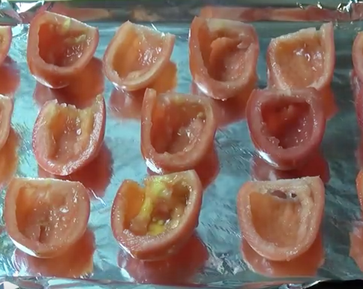 step 3 Slice in half lengthwise then simply use a teaspoon to get rid of the seeds and the watery bit from the center of the tomatoes. Then we can arrange tomatoes onto a baking tray lined with some aluminium foil.