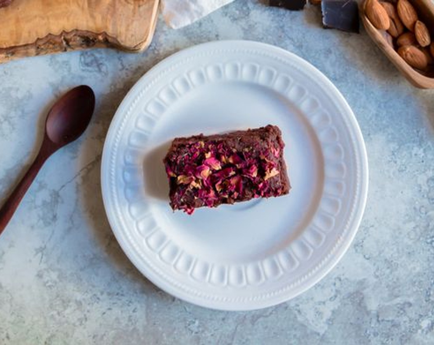 step 7 Once baked, remove from the oven and leave until the brownies are cooled before removing them from the tin. Cut into 16 squares. If desired, decorate with Edible Dried Rose Petals (to taste).