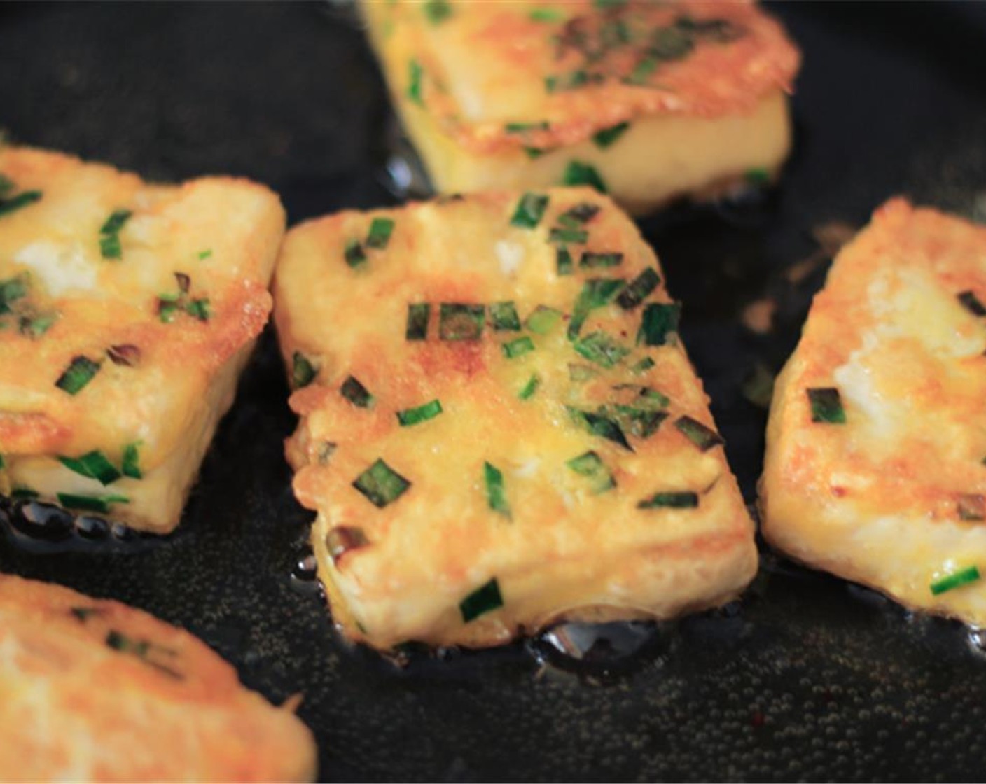 step 4 Pour Frying Oil (as needed) in a pan and lay the slices in one by one. Fry until both sides of the tofu are golden brown.