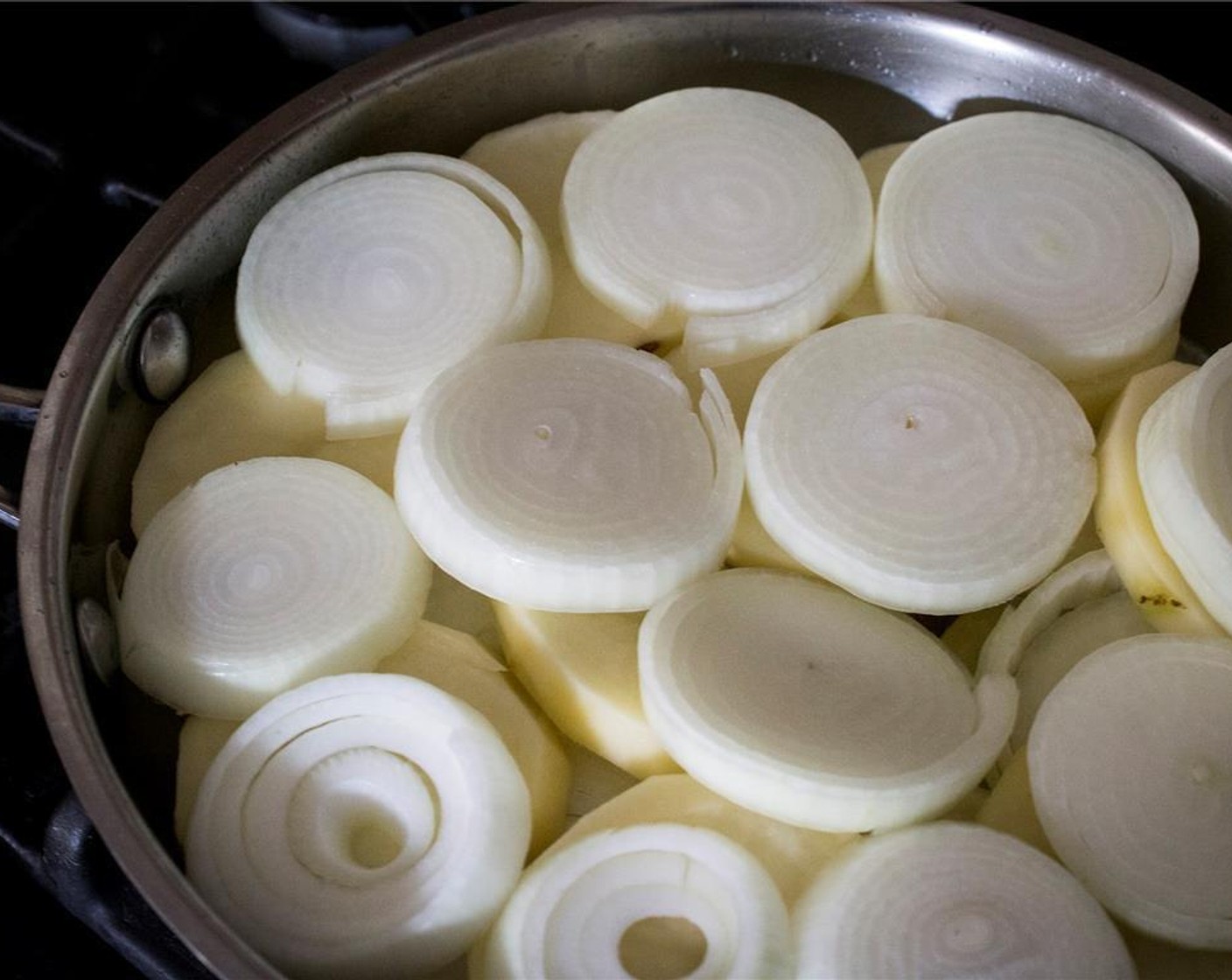 step 3 Heat 2/3 of the Olive Oil (1/2 cup) in a 8-9 inch skillet (nonstick helps). Add the slices of potatoes in a single layer, covering the bottom of the pan, then alternate layers of potato with layers of onion.