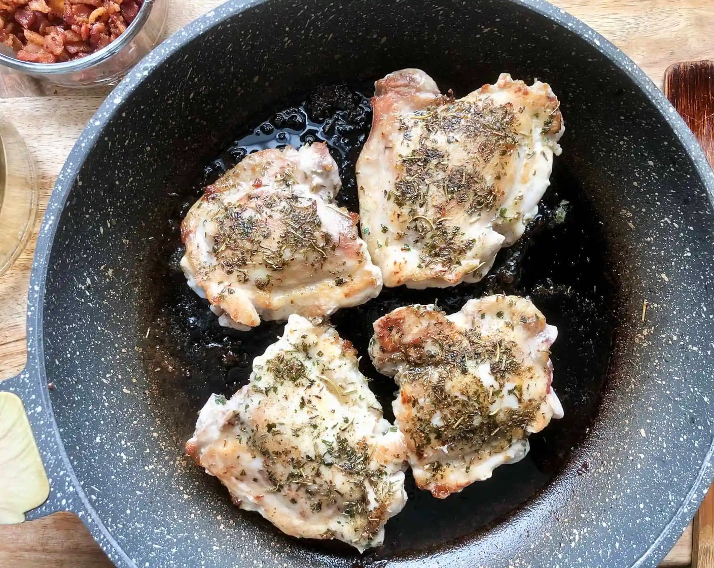 step 2 Sprinkle Bone-In Chicken Thighs (1.5 lb) with the Dried Mixed Herbs (1/2 Tbsp). Add chicken to bacon drippings in pan, cook for about 8 minutes, browning on all sides.