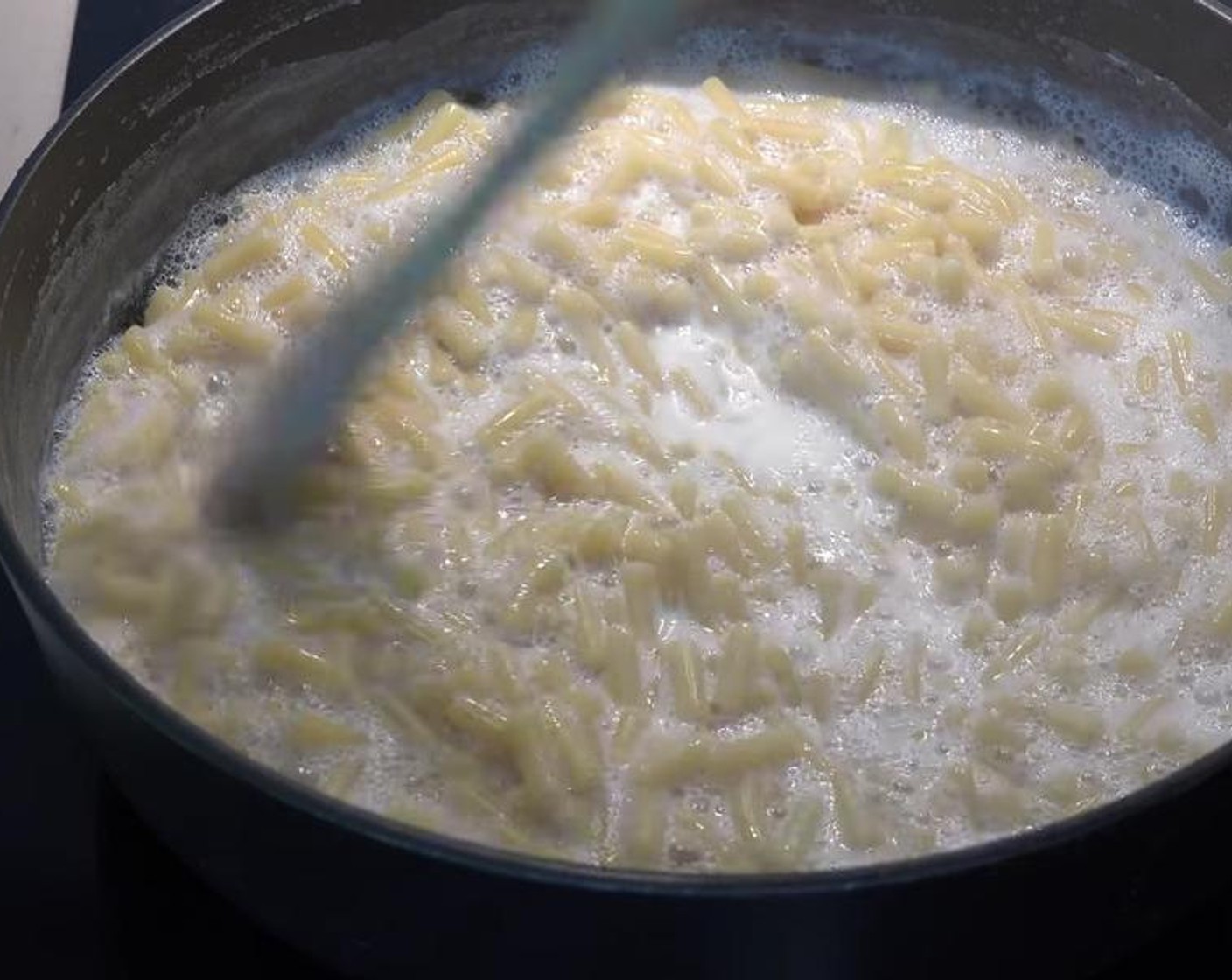 step 2 Add Elbow Macaroni (1.1 lb) to the milk. Cook for about 10 minutes or until the pasta is completely cooked. Stir continuously. Turn the heat off and take off the heat completely.