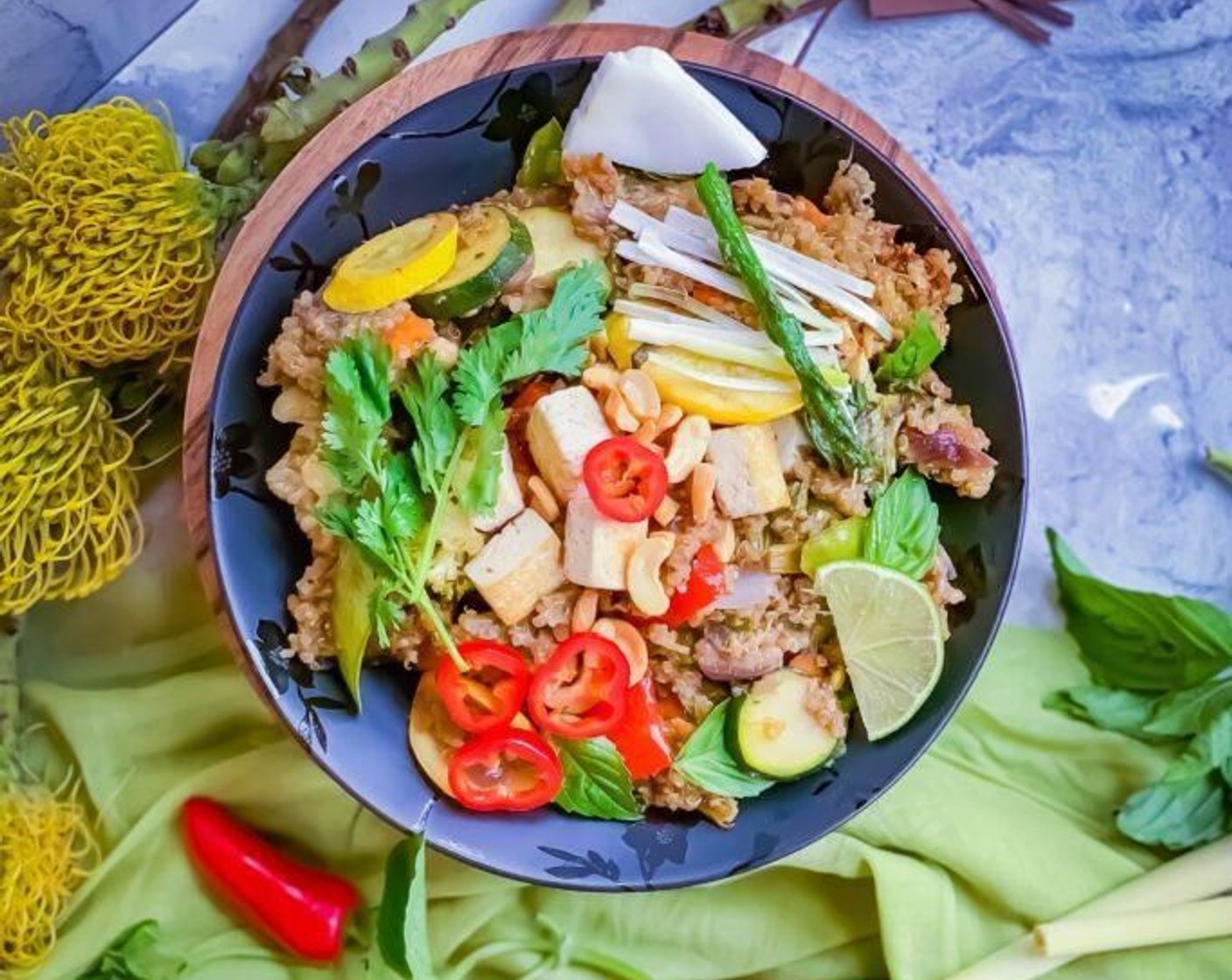 step 15 Stir one last time to incorporate all the flavors into Thai Green Curry Quinoa. After transferring to the serving plate, top it with crisp tofu and Cashew Nuts (1/4 cup).