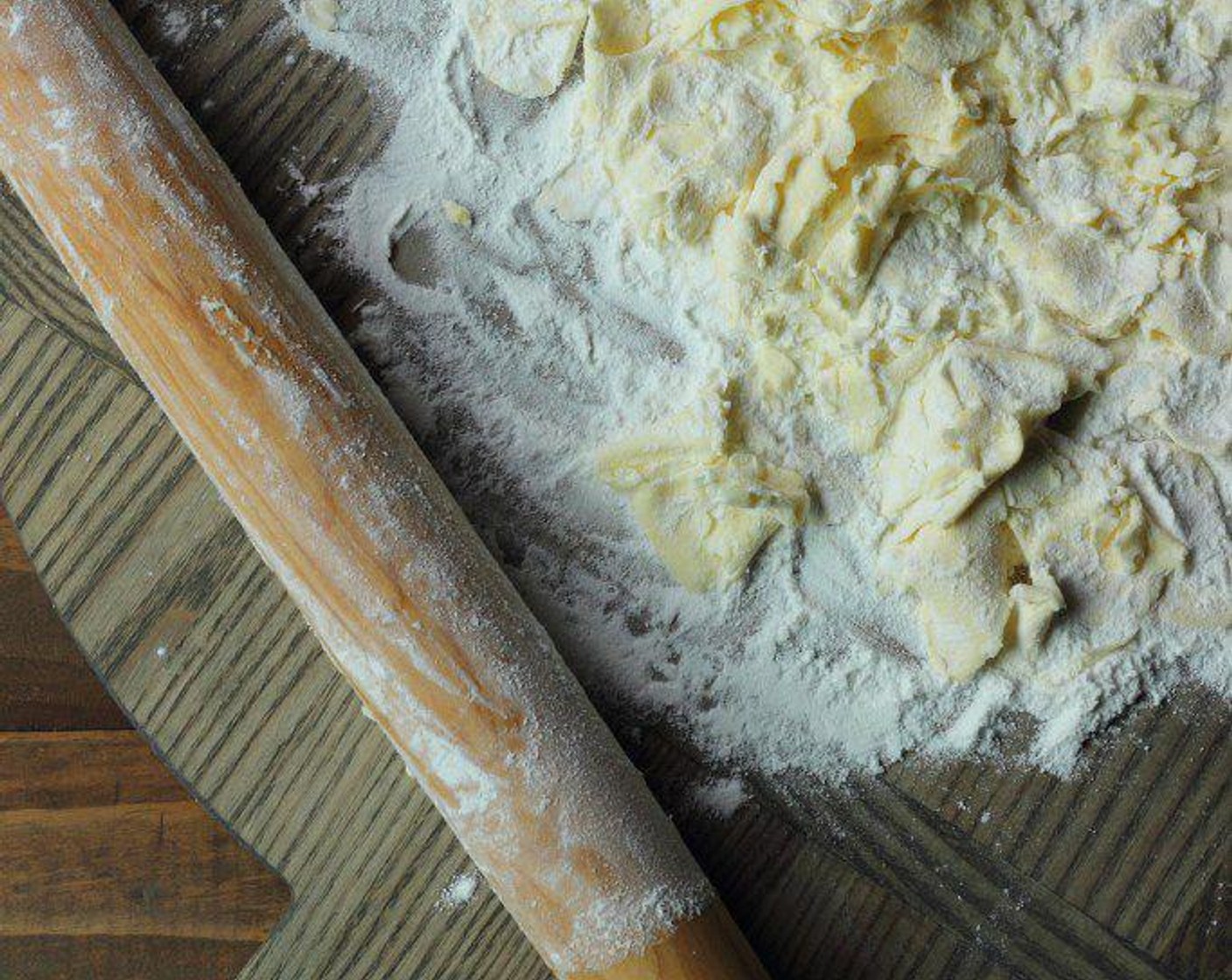 step 4 With a rolling pin, roll the butter cubes until they are all flat, distributing flour on top as necessary.