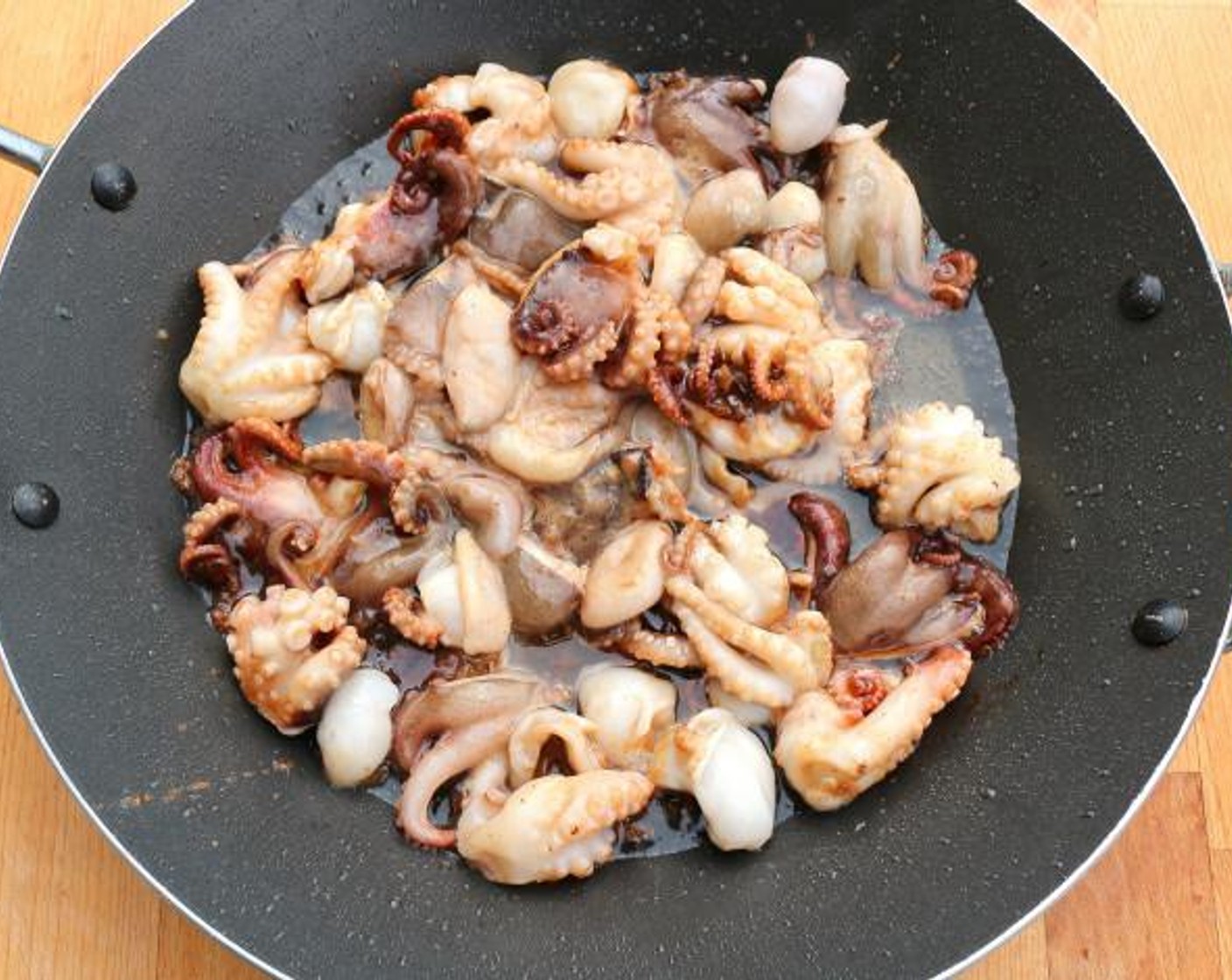 step 5 Stir fry the baby octopus in VERY HOT Peanut Oil (1 cup) for 1 minute, remove with a slotted spoon to a thick layer of absorbent paper, discard all but 1 tablespoon of the remaining peanut oil.