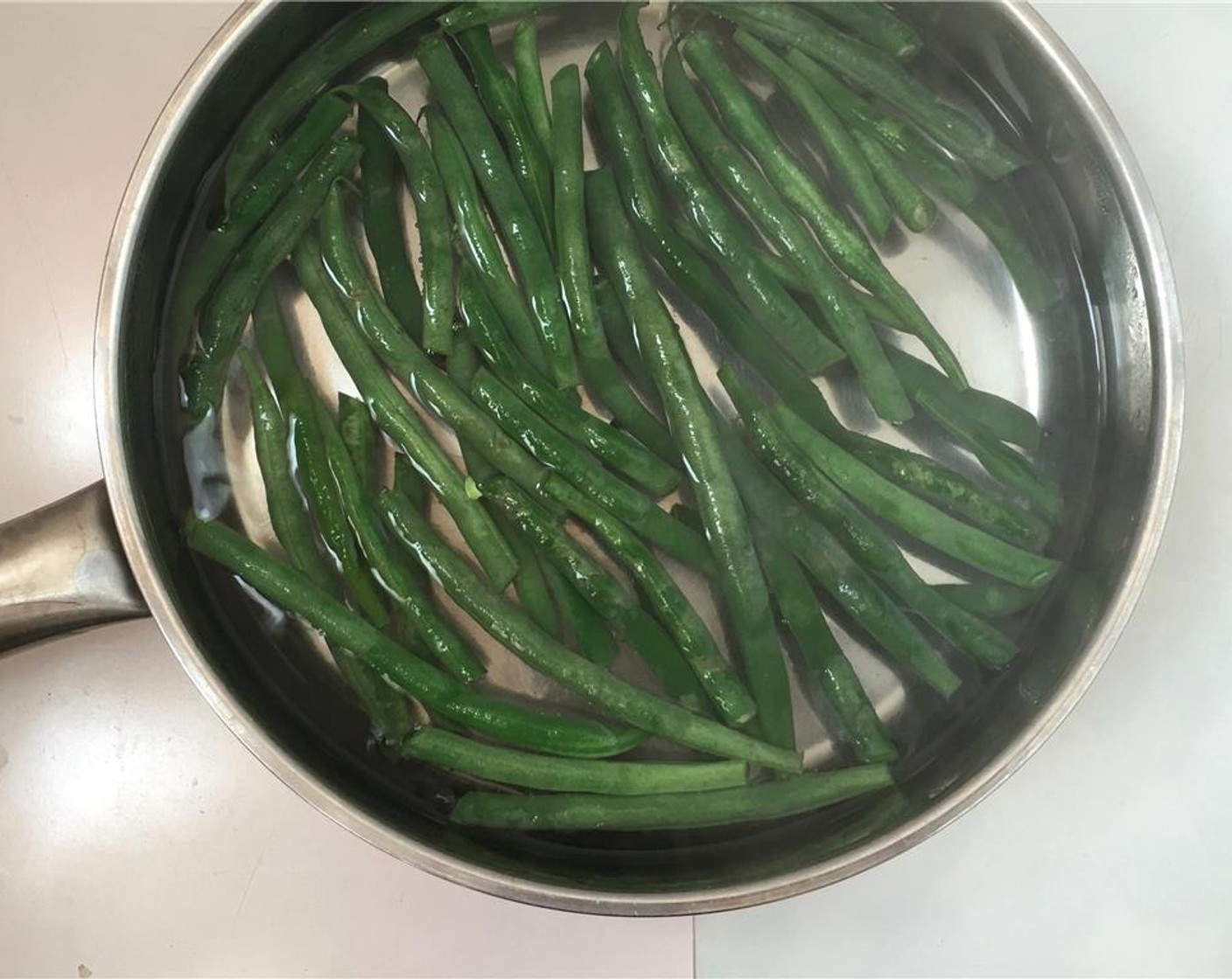 step 1 Trim the Green Beans (1 handful) and cut any long ones in half. Rinse the beans. Bring a large pan of water to a good boil, add Salt (to taste) and the green beans.